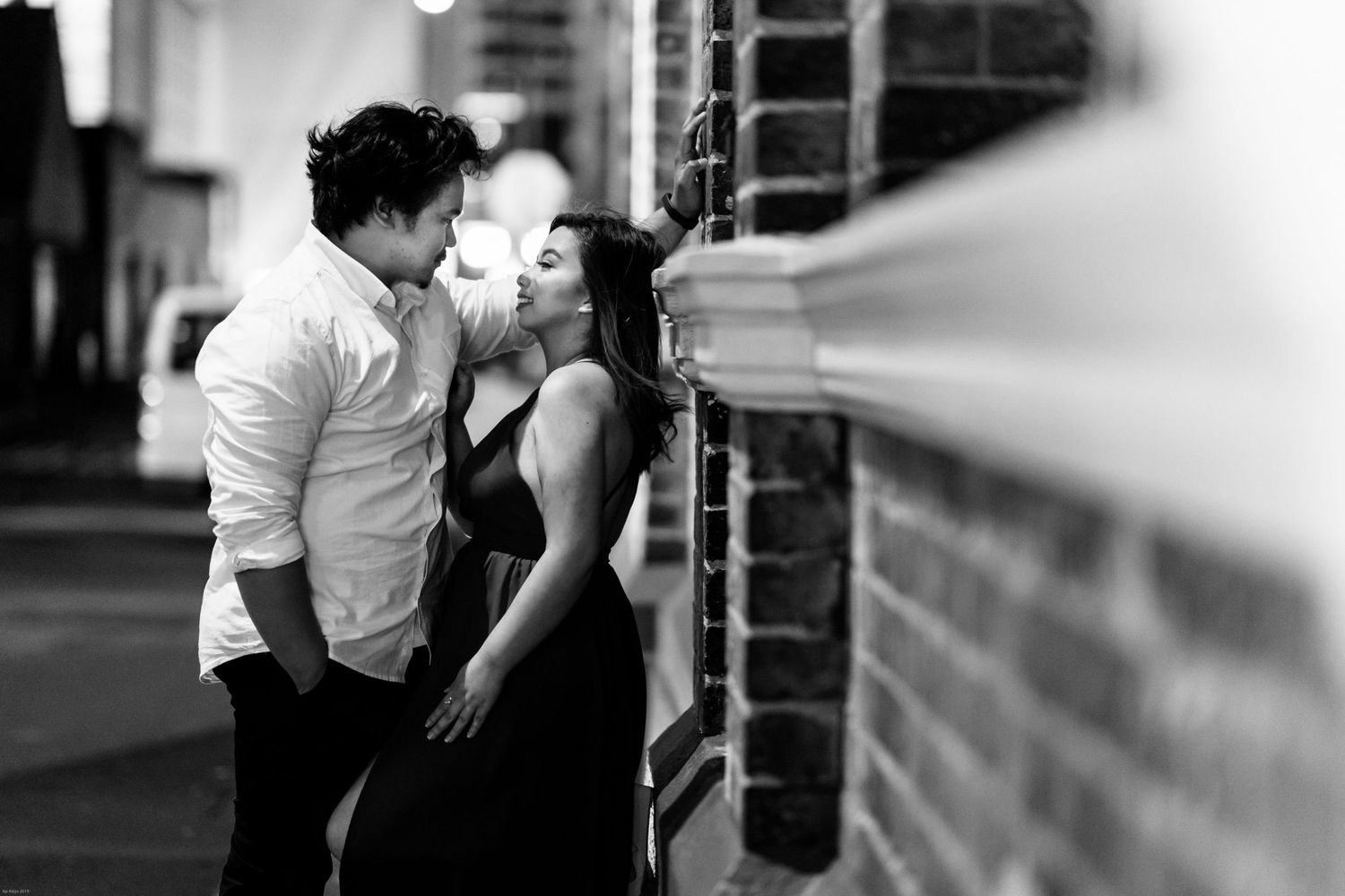 Couple embracing in a romantic black and white photo shoot.