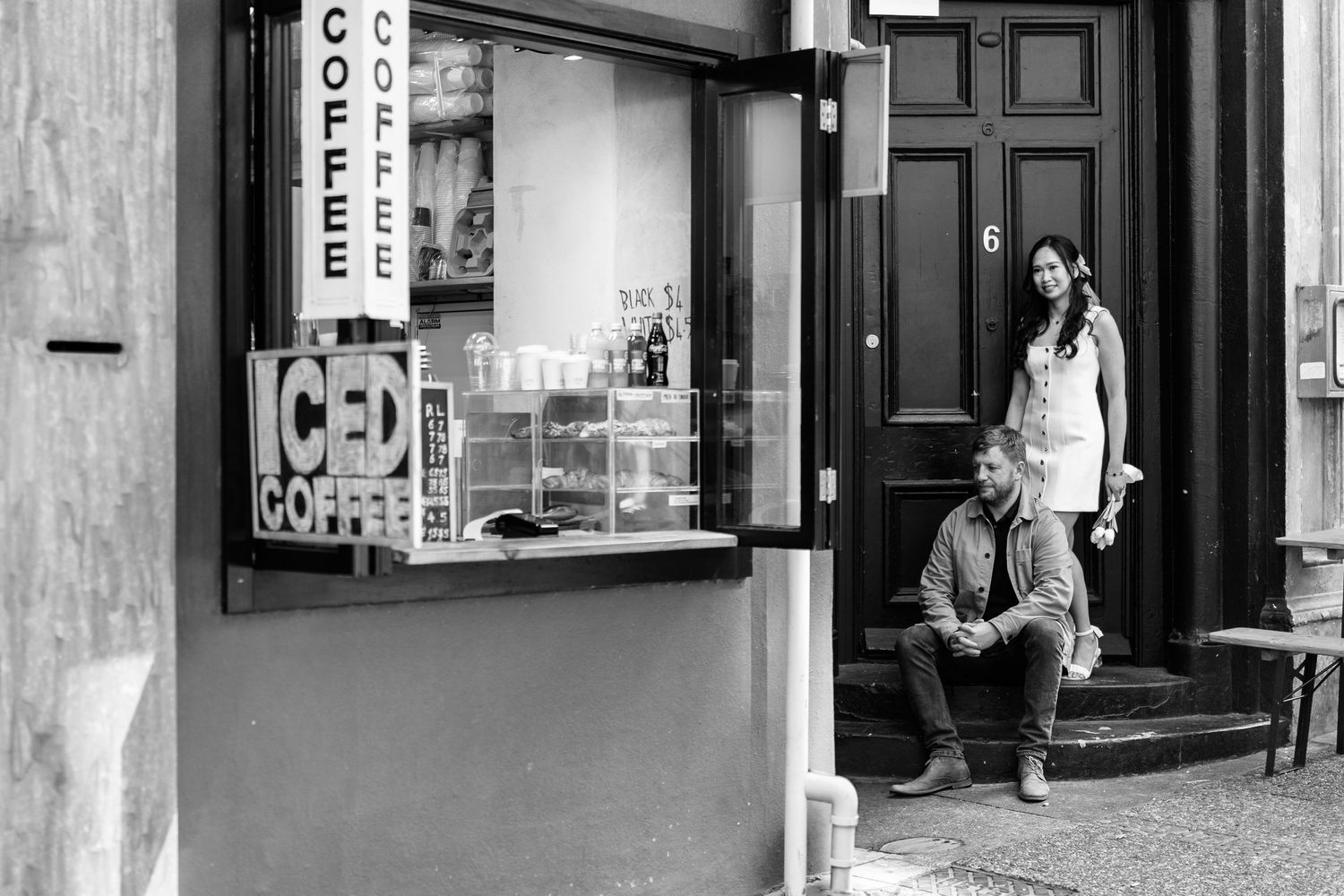 Black and white urban storefront with classic architectural details.