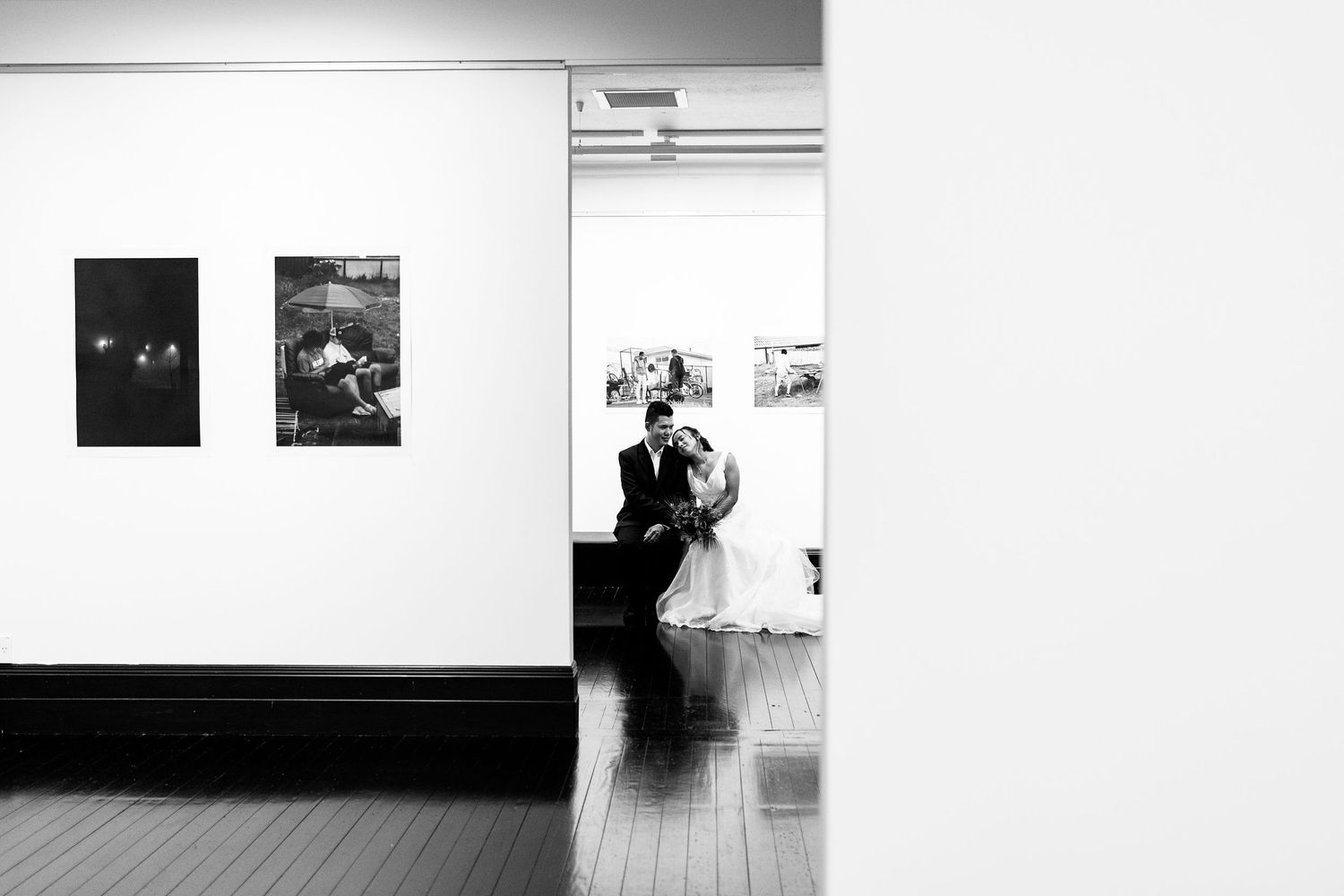 Black and white artistic wedding photographs arranged in a gallery wall display.