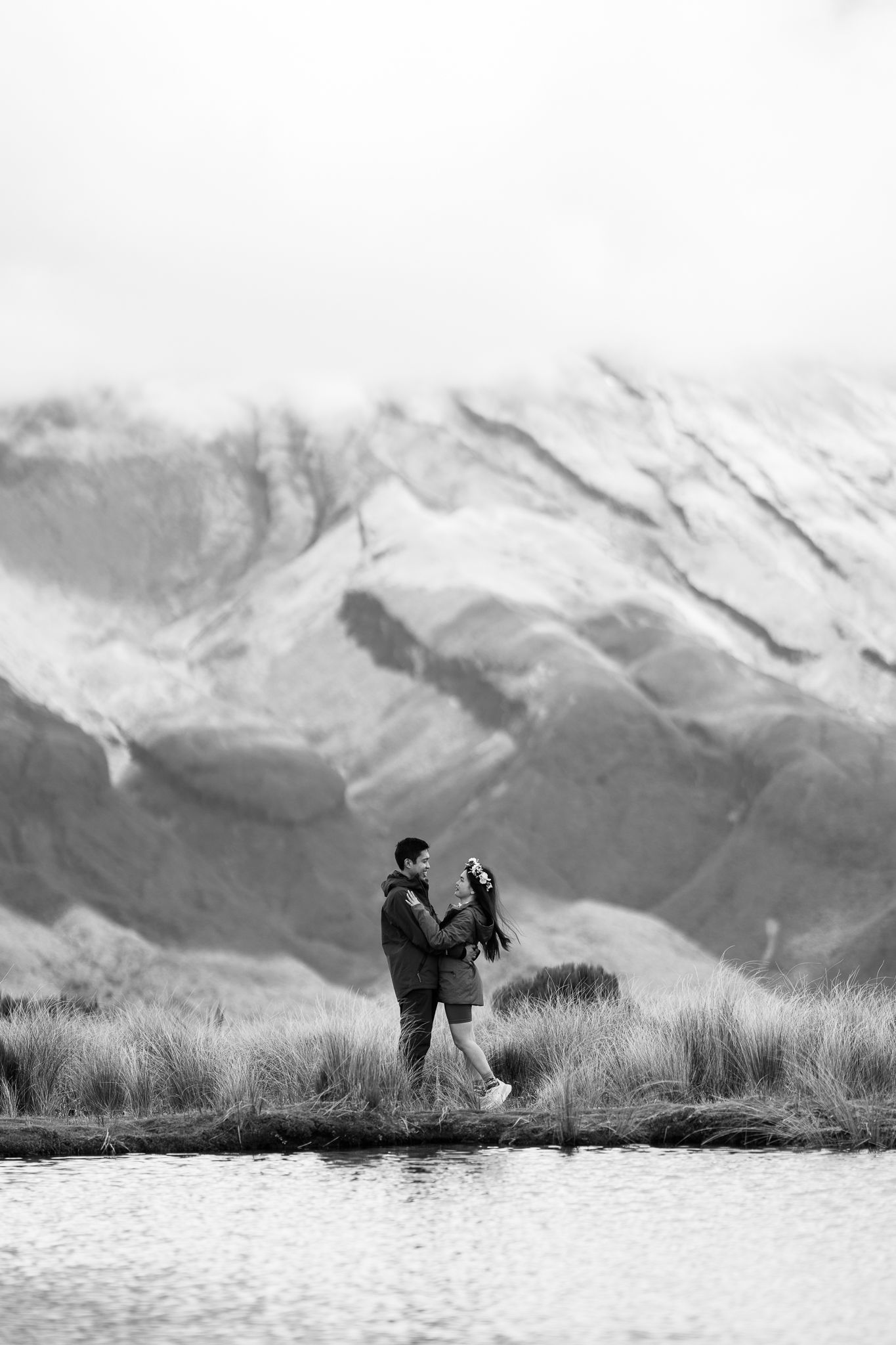 Silhouetted figures against snowy mountain landscape during golden hour.