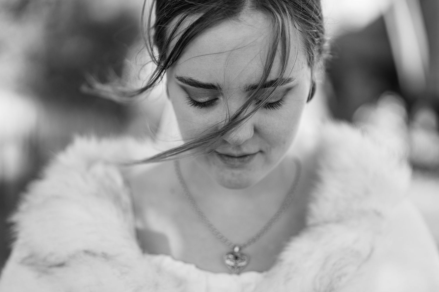 Close-up portrait of bride wearing white fur wrap.
