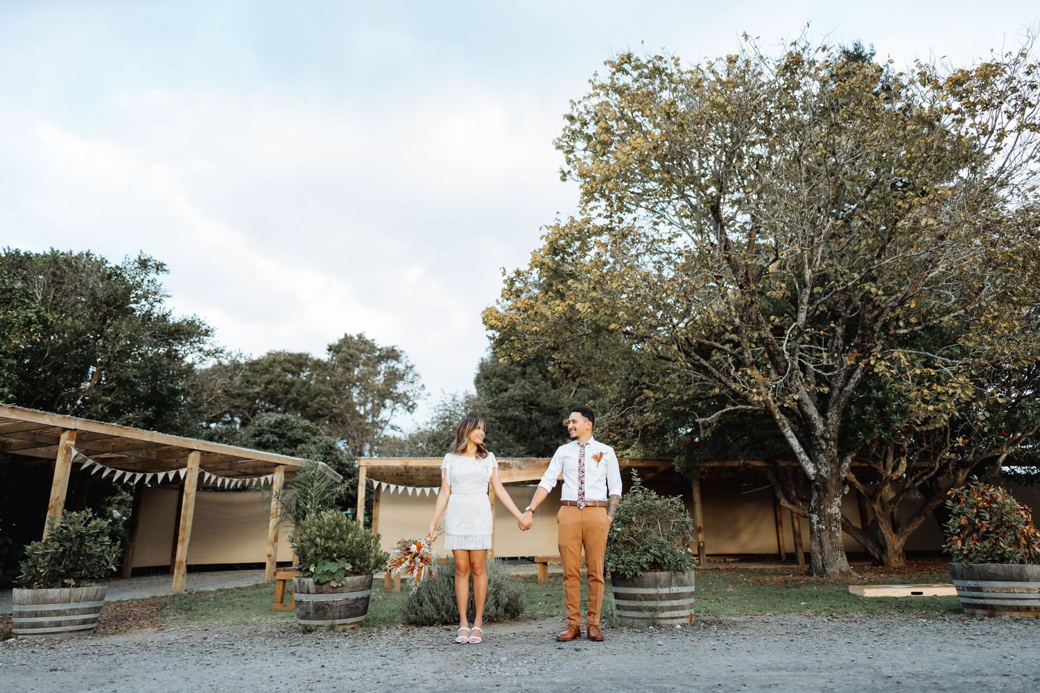 Panoramic view of an outdoor wedding venue with natural landscape and seating areas.