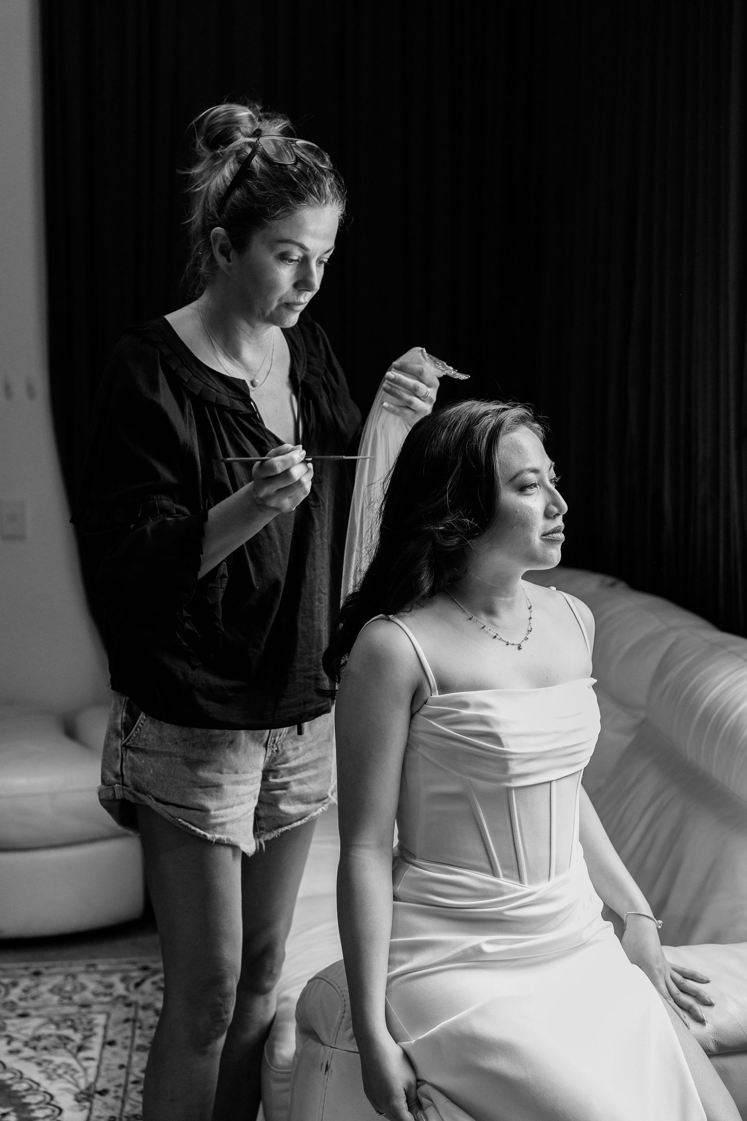 A bridal preparation scene with flowing white dress details.