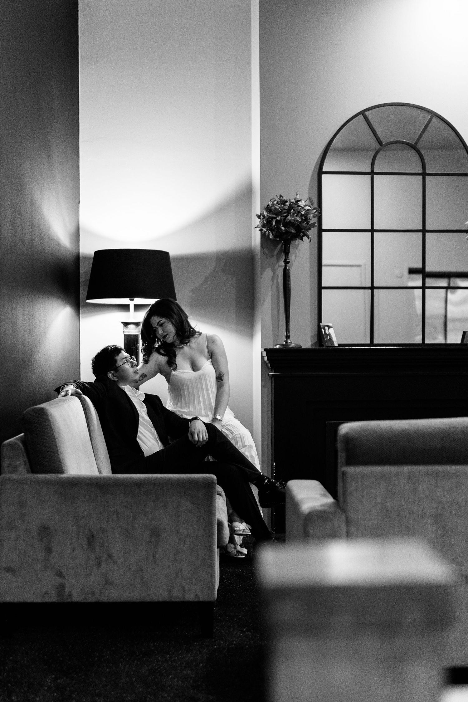 Black and white interior photos showing intimate moments on living room couch.