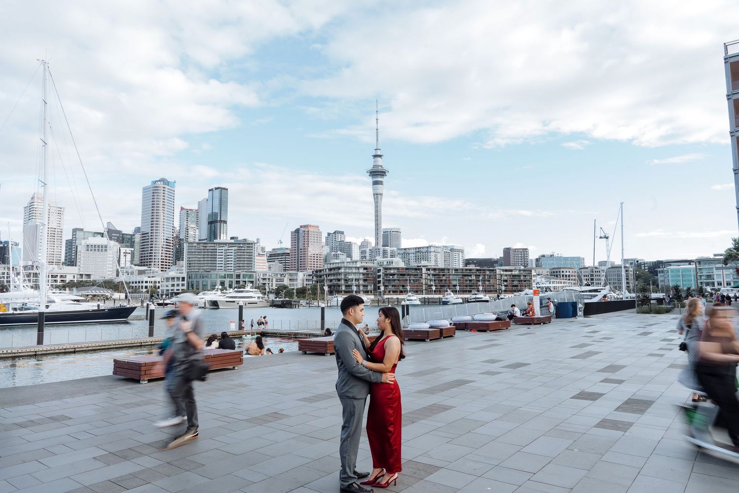 Urban waterfront plaza with Auckland Sky Tower visible in the background.