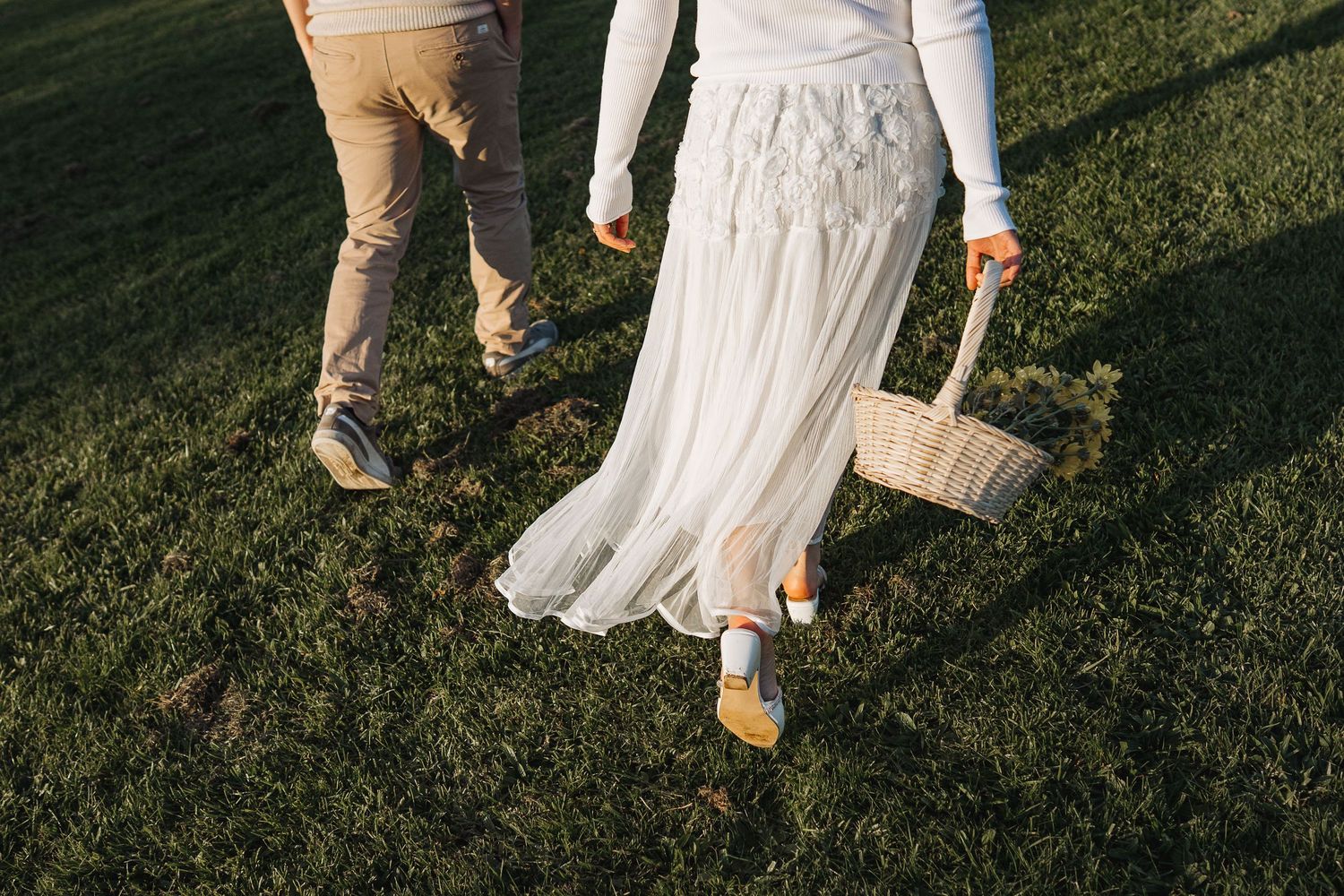 Close-up shots of feet walking on grass in casual and formal shoes.