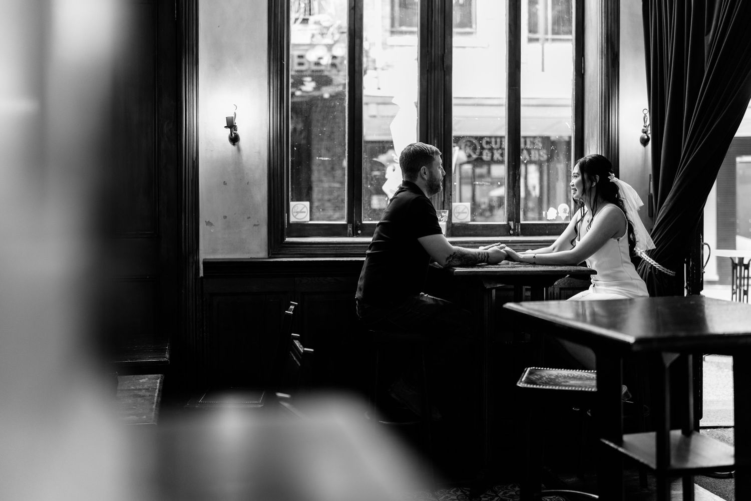 Moody black and white interior shots of a room with dramatic window lighting.