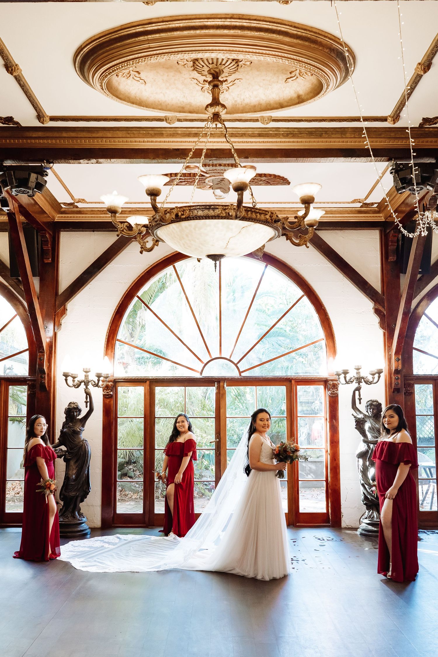 Elegant wedding venue interior with ornate ceiling details and large windows in panoramic view.