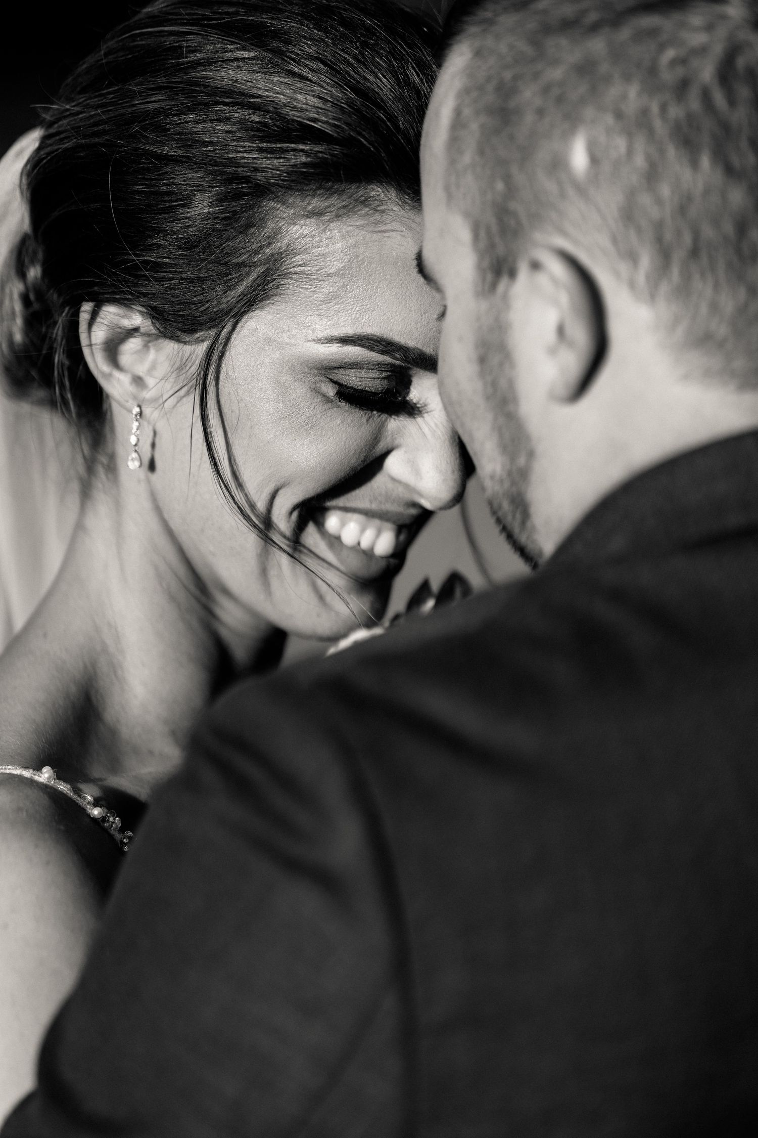 Intimate black and white wedding portrait capturing a tender moment.