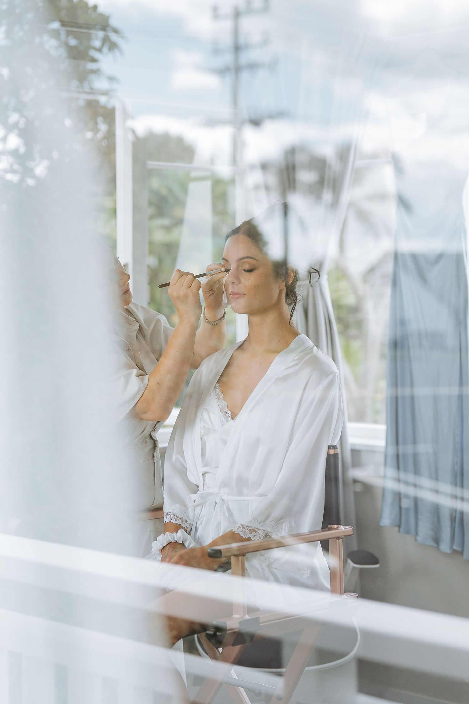 Soft morning light streams through windows during wedding day preparations.