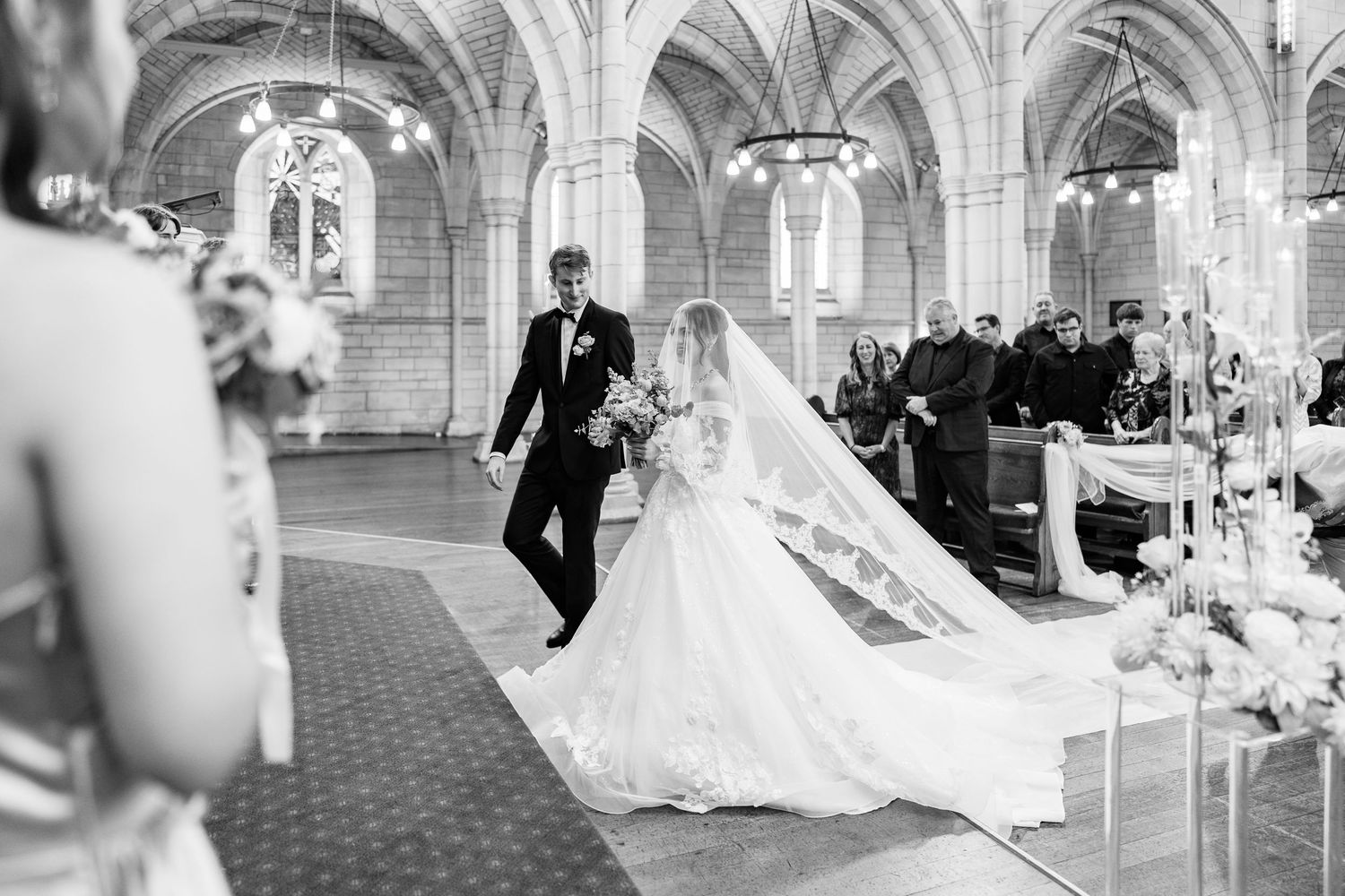 Elegant church wedding ceremony with gothic arches and decorative details.
