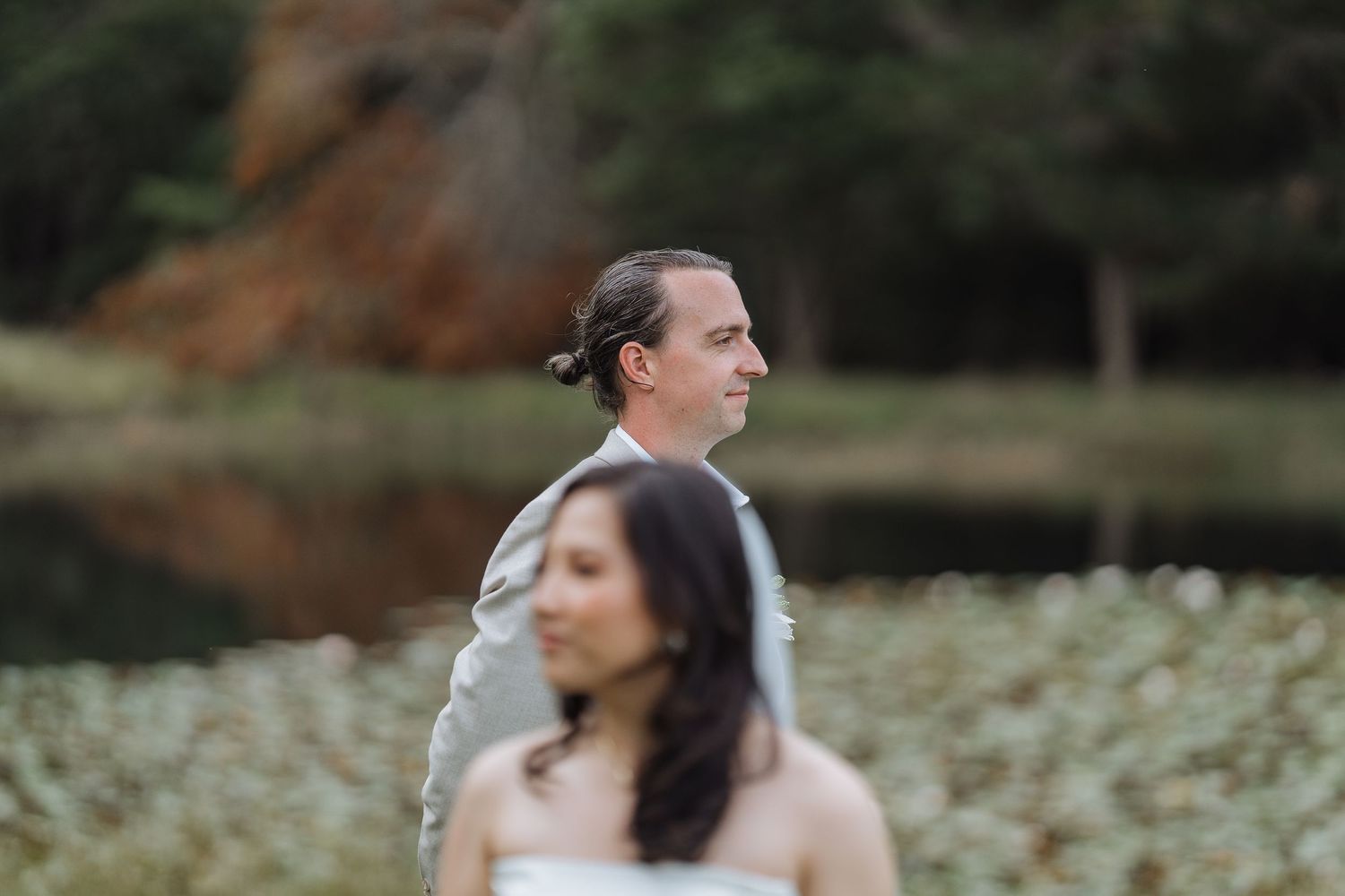 Artistic wedding portrait with selective focus during outdoor ceremony.