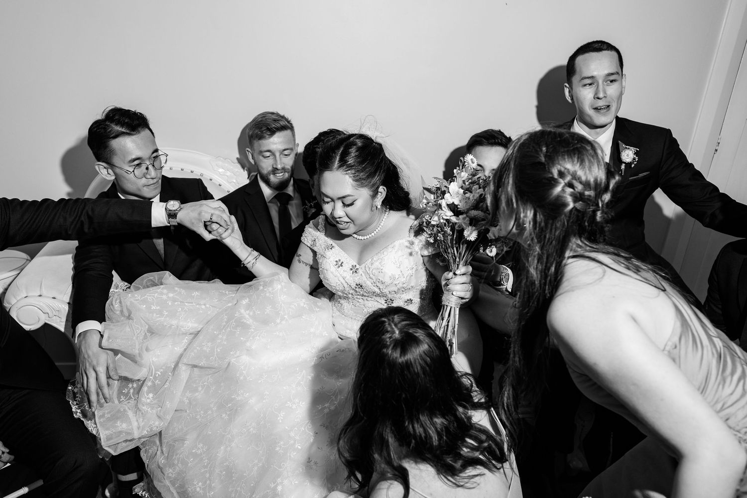 Black and white candid shots of a wedding celebration with guests in formal attire.