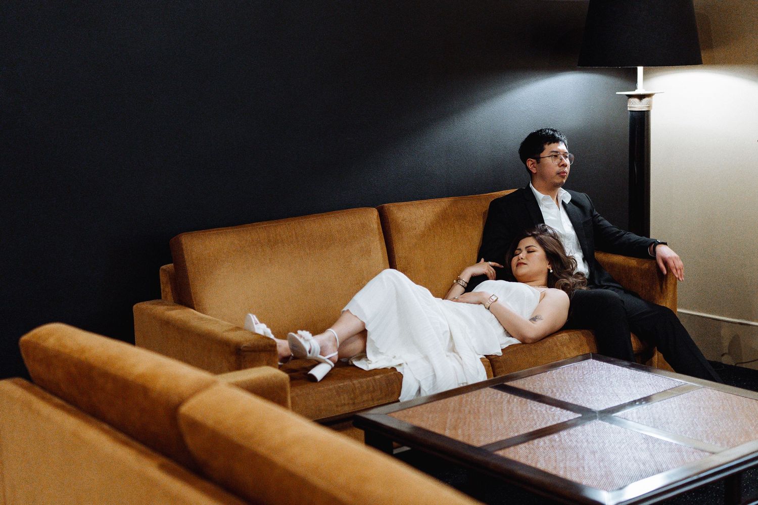 Relaxed lounge scene with warm lighting and comfortable seating arrangements.