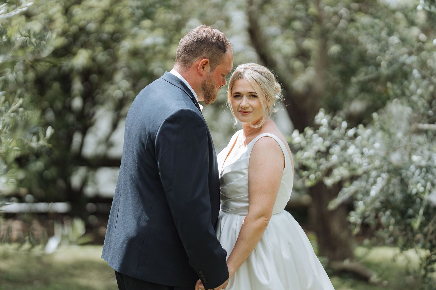 Romantic garden wedding portraits with soft natural lighting.