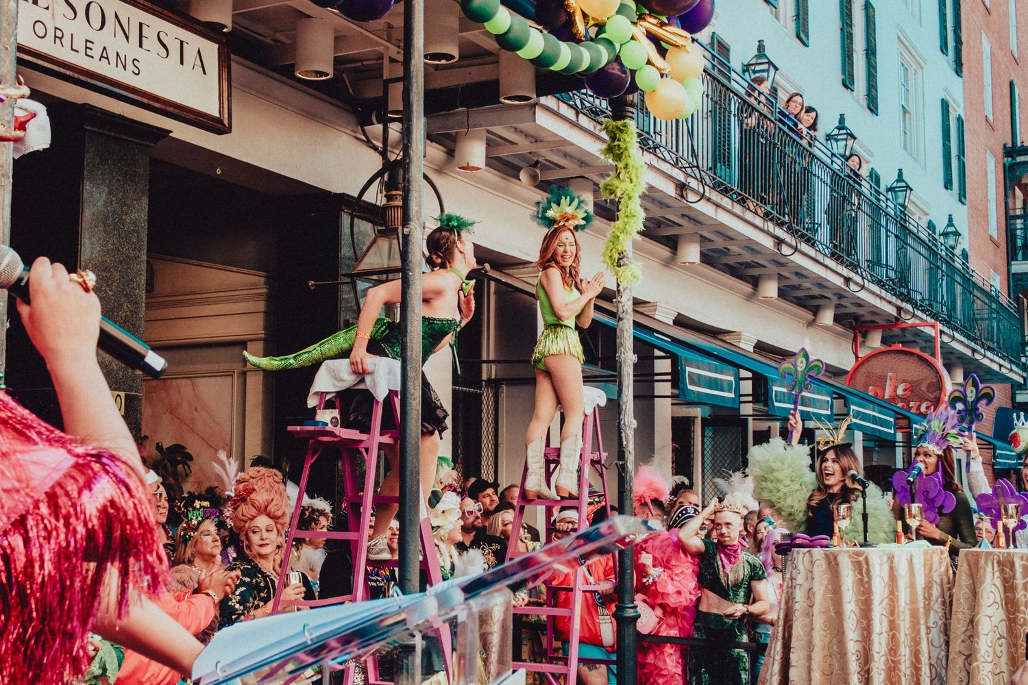Festive street celebration outside Royal Sonesta with colorful balloons and decorations.