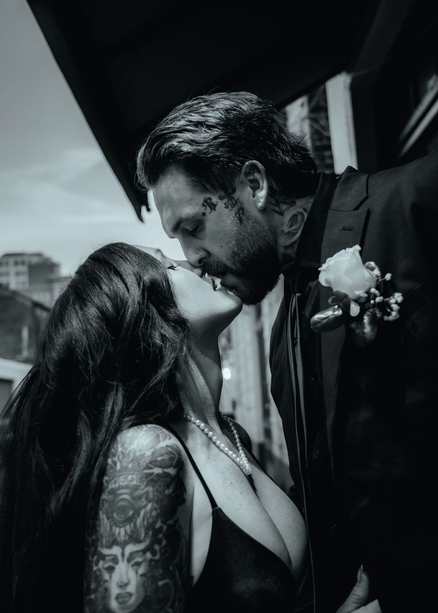 A romantic black and white photo series showing a couple embracing and kissing in four successive intimate moments.