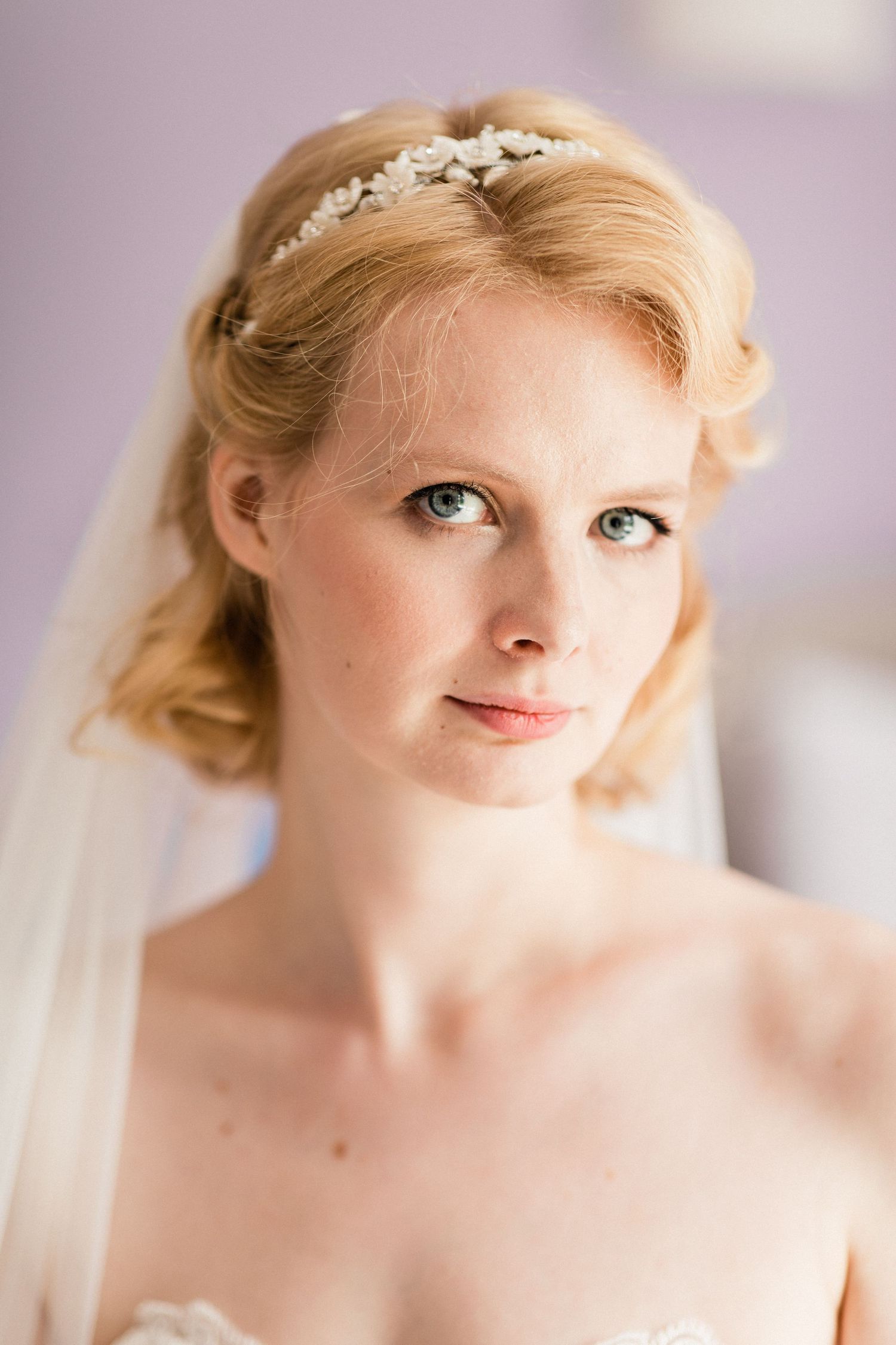 Bride gazing softly in elegant close-up before ceremony in Hallines, France