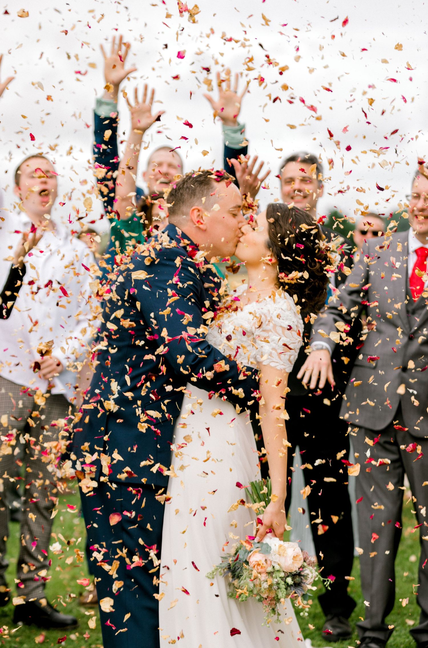 Natural, documentary-style photo of couple during confetti toss
