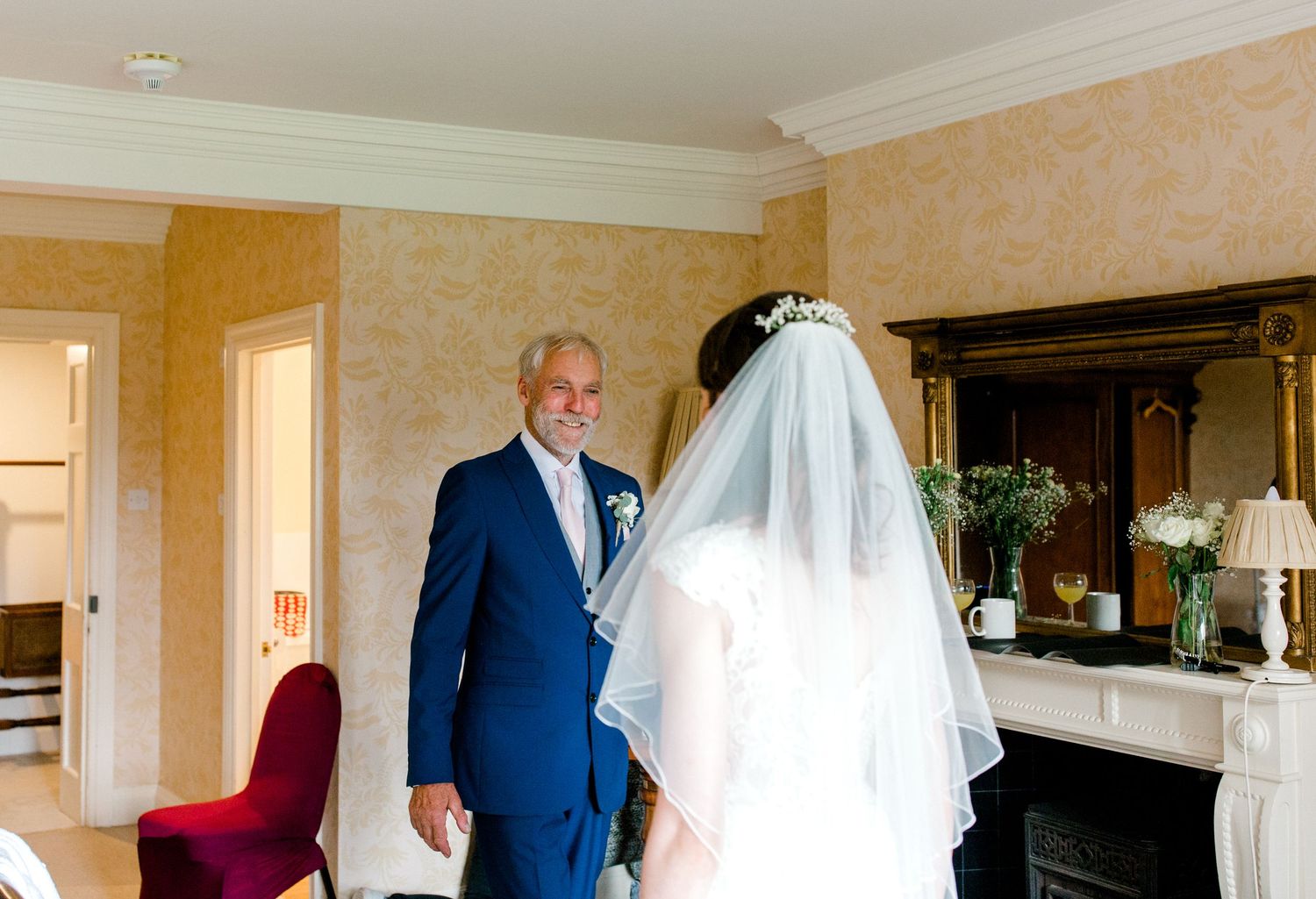 Emotional first look between bride and father – candid wedding photography Hoath House Edenbridge Kent