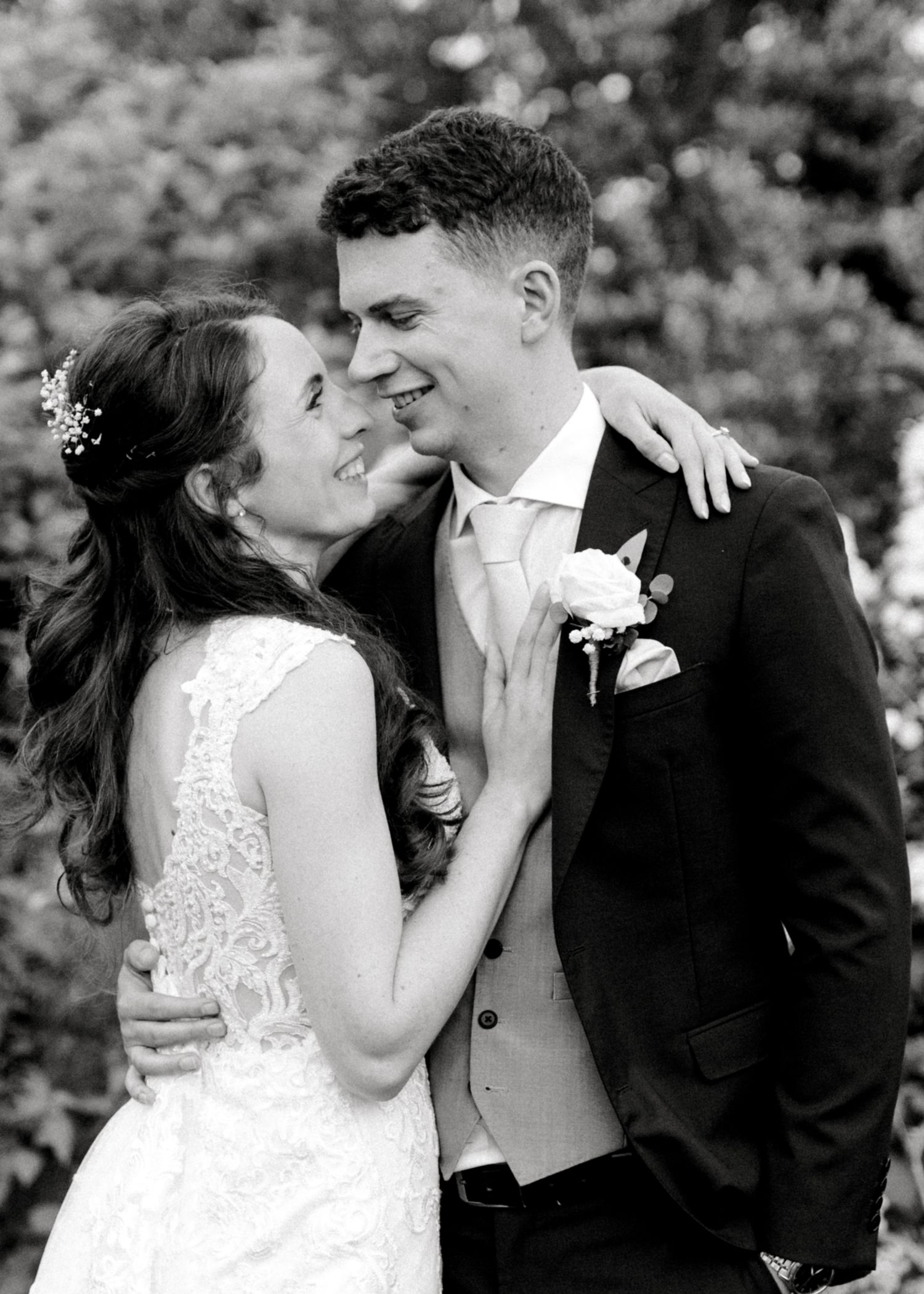 Beautiful wedding portrait featuring bride and groom in romantic embrace outdoors in Kent venue