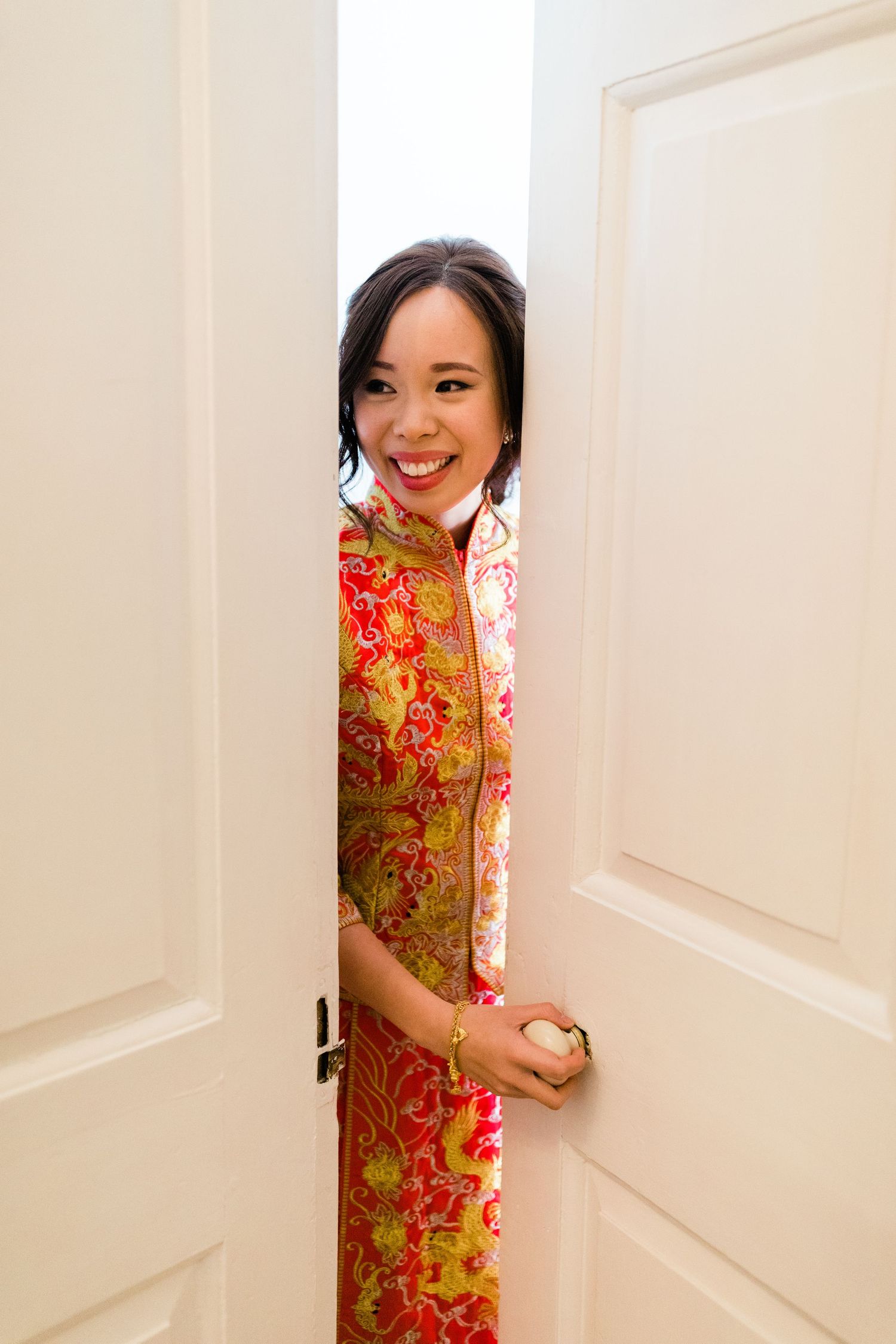 Bride waiting for the groom to finish games before tea ceremony Gosfield Hall Essex