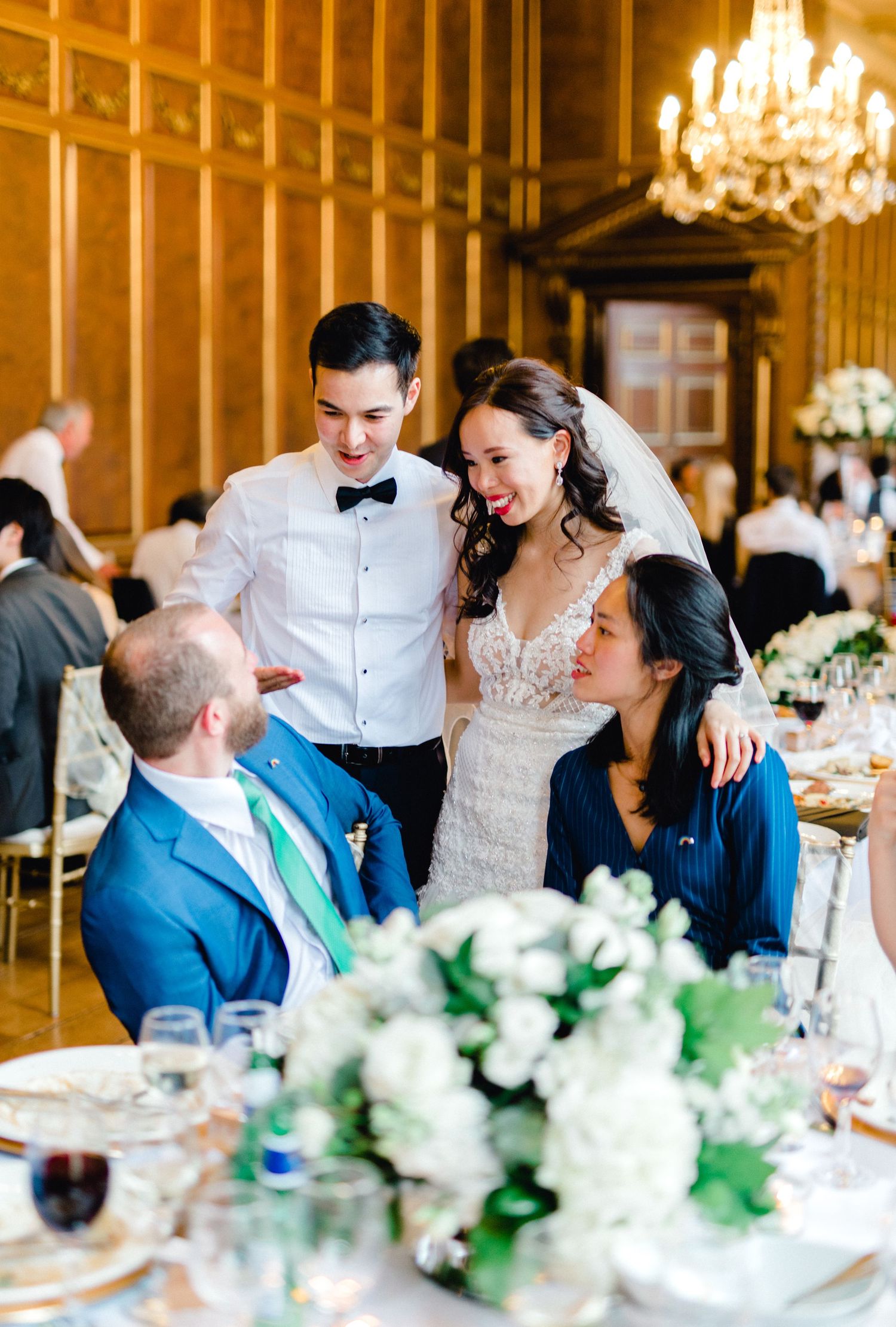 Bride and groom having a lovely conversation with guest candid wedding photography Gosfield Hall Essex