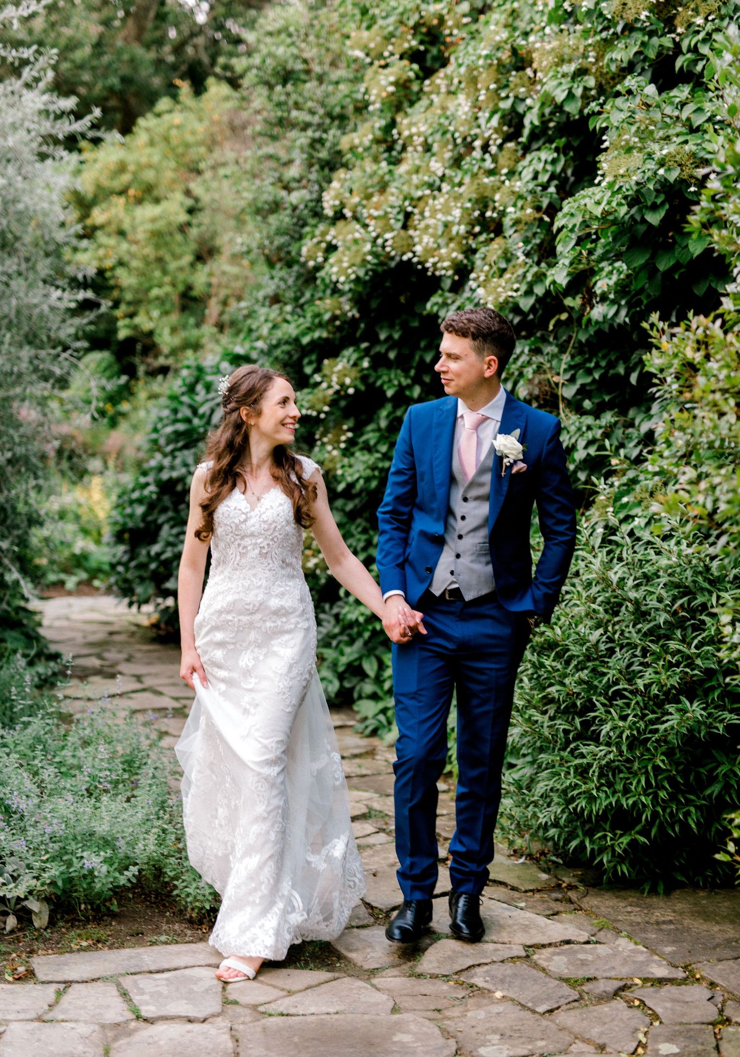 Bride and groom approaching camera outdoor wedding portrait photography in Kent