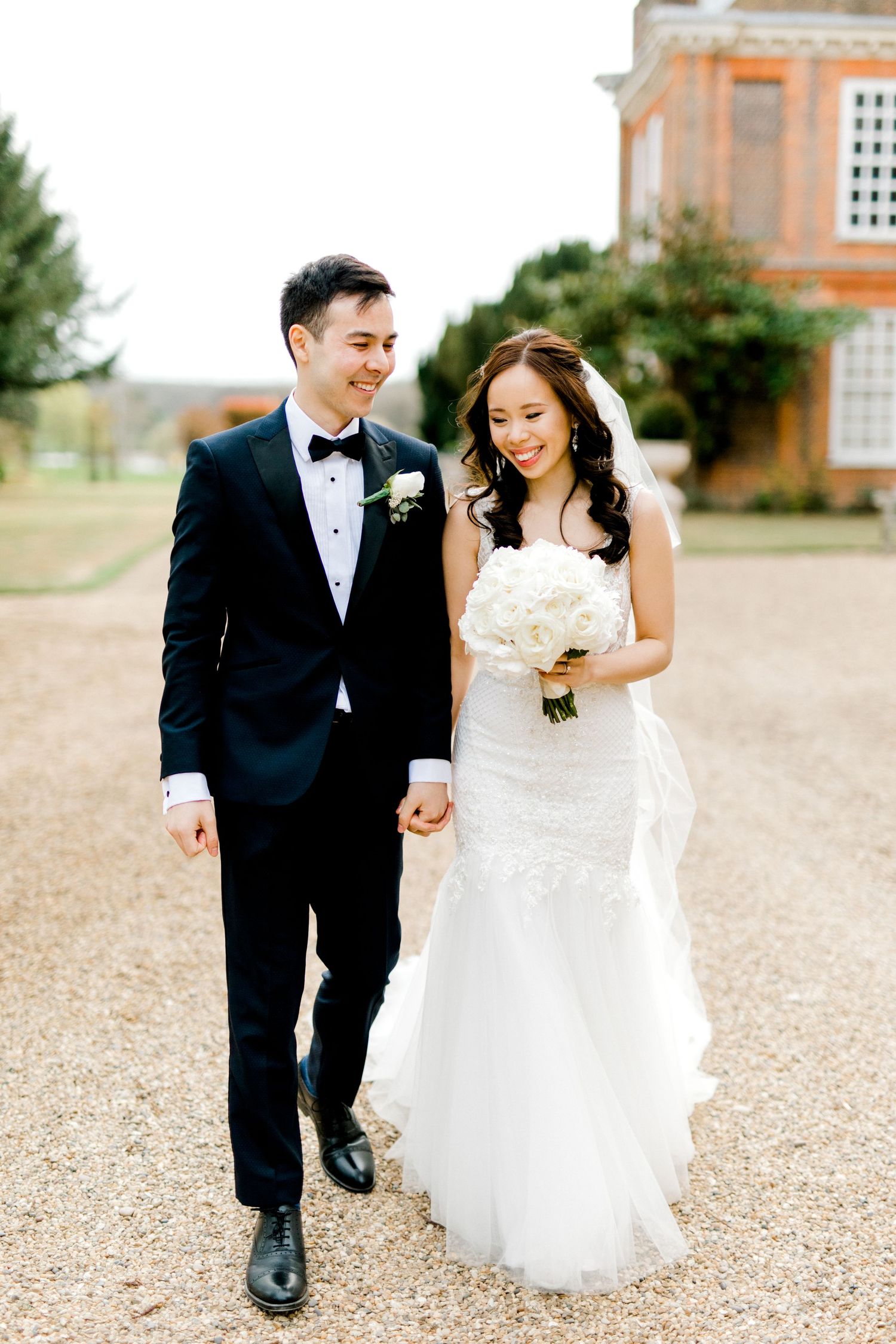 Wedding couple walking toward camera romantic portrait session in Essex