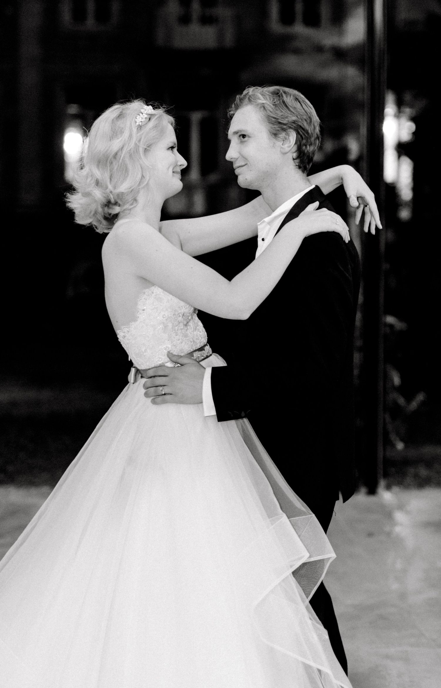 Bride and groom laughing during fun first dance at wedding reception celebration