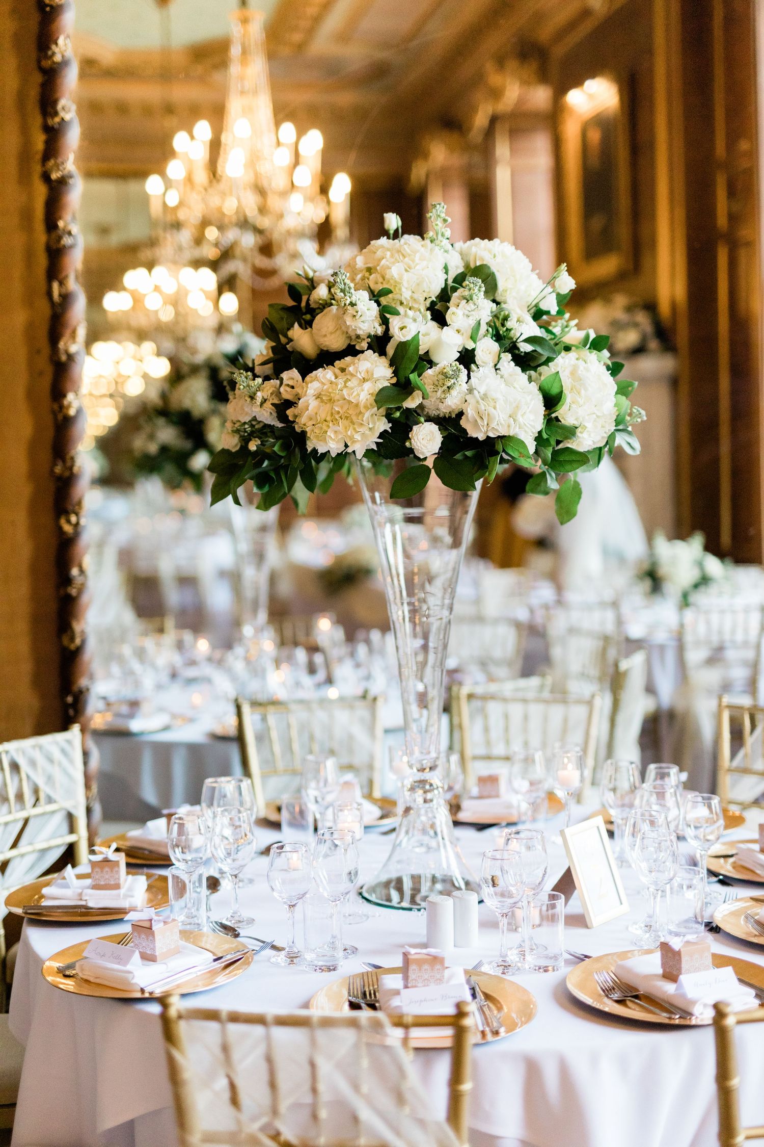 Classic white rose centerpiece elegant reception table decor in Gosfield Hall Essex