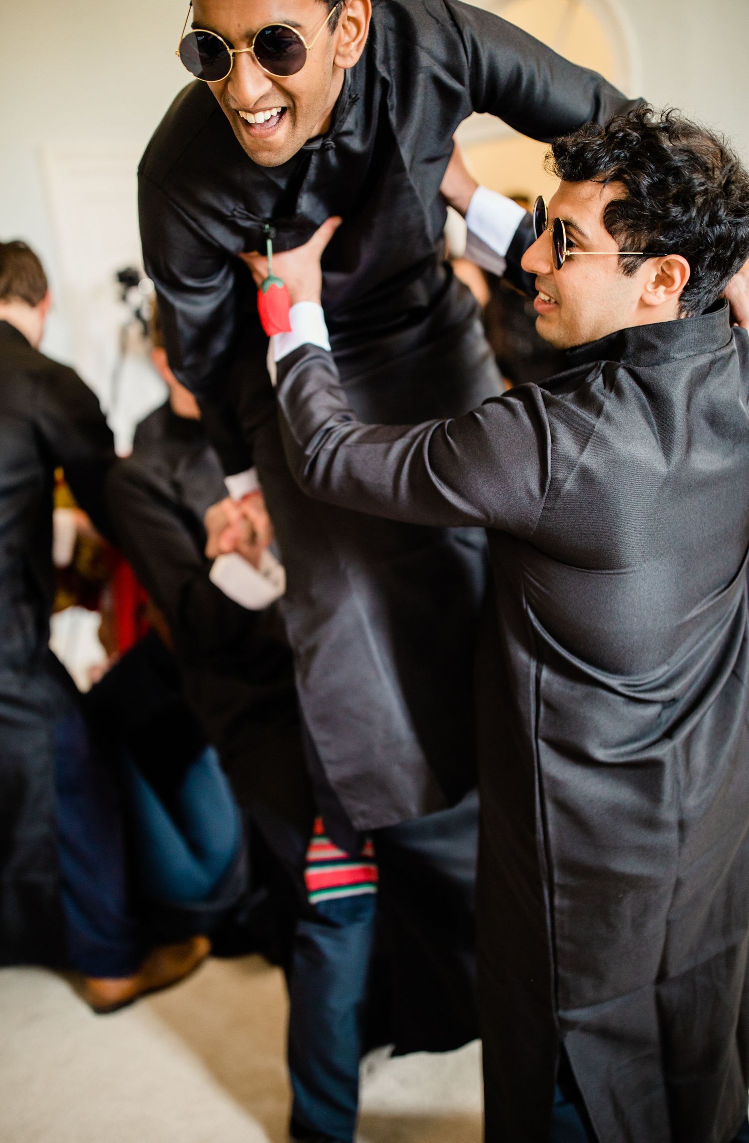 Groomsmen in fun tea ceremony games Gosfield Hall Essex - candid wedding photography