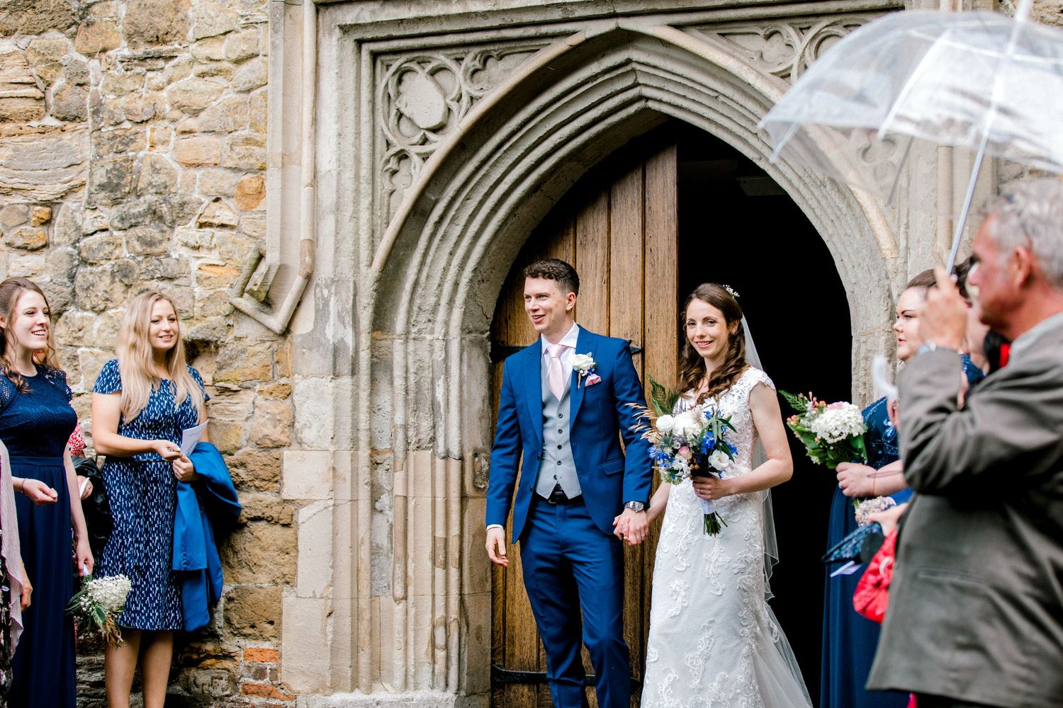 Bride and groom coming out of church following church ceremony in Edenbridge, Kent