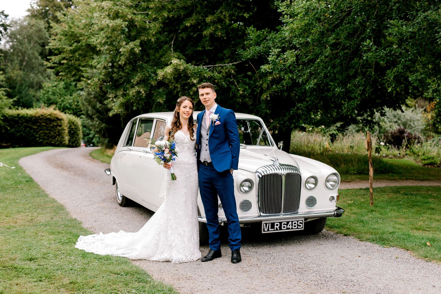 Bride and groom portrait in front of a formal wedding car - Hoath House, Kent