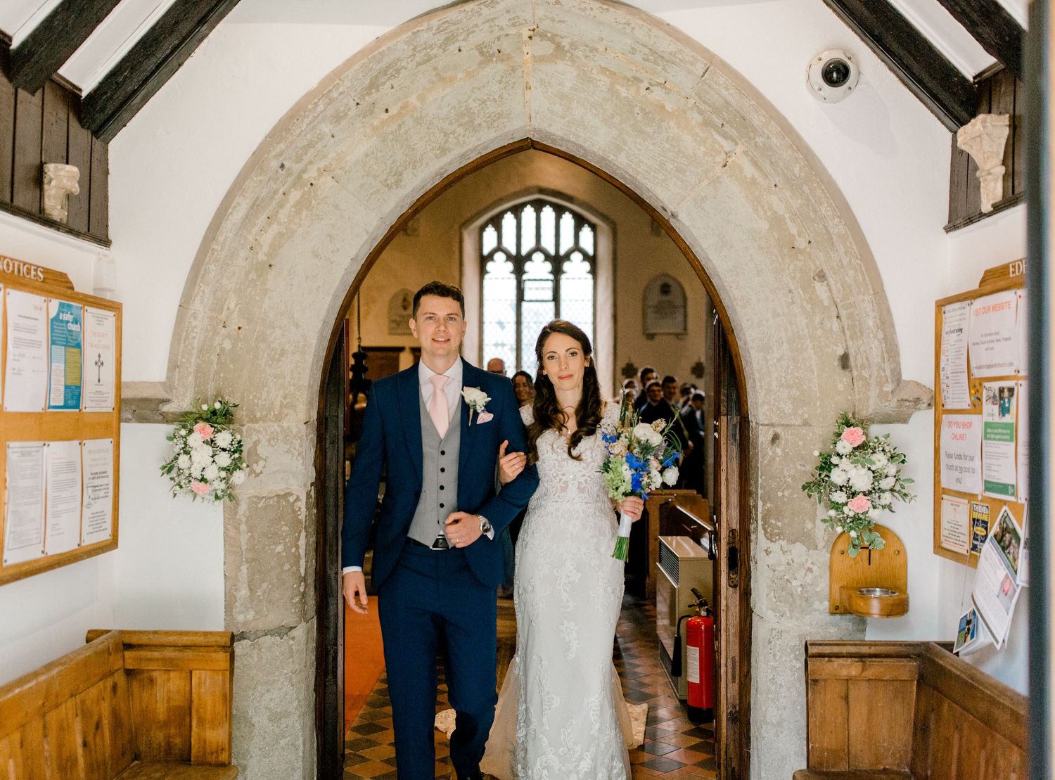 Couple exiting church just married in Edenbridge Kent wedding