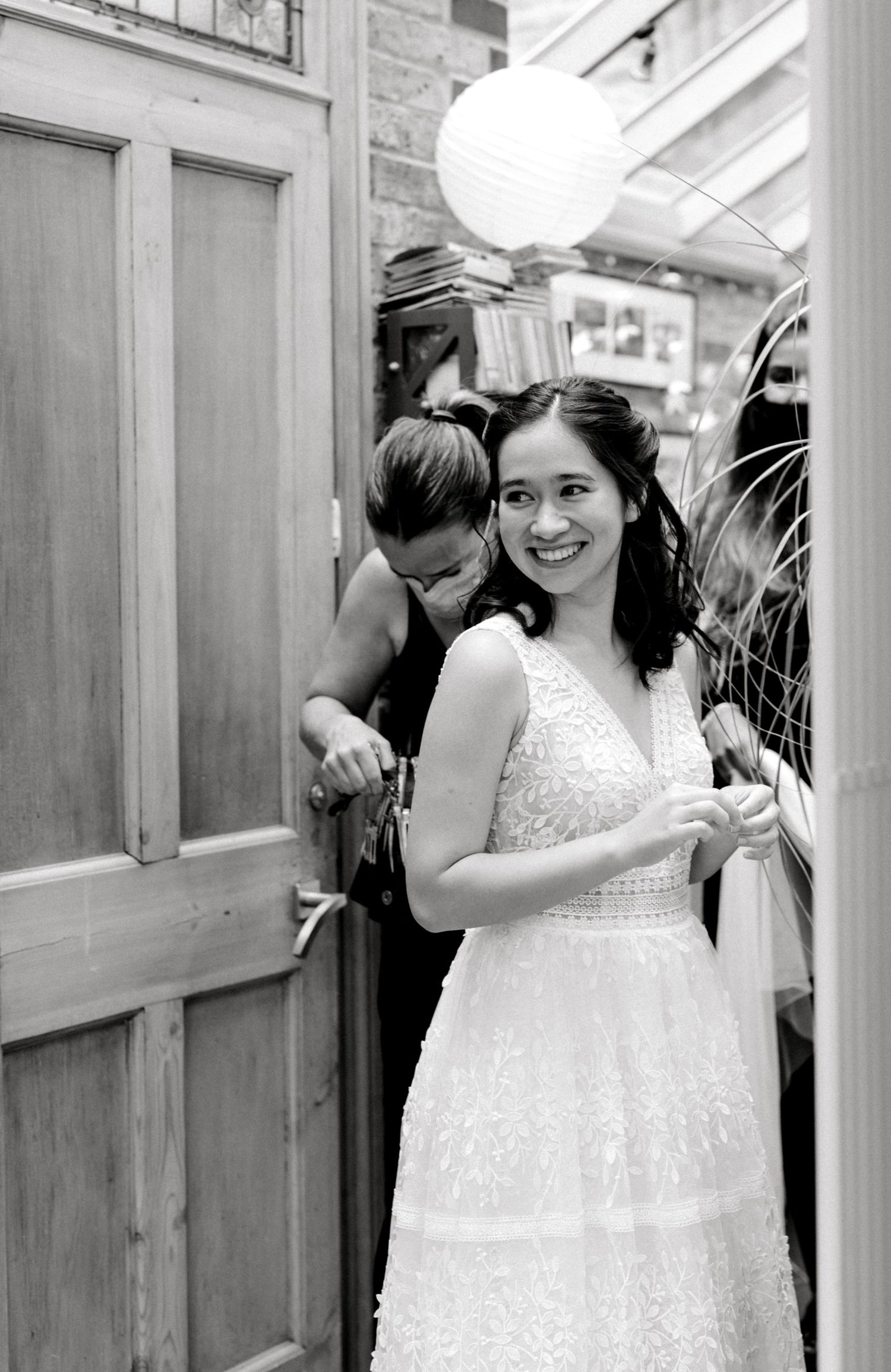 Final touches before the ceremony — bride adjusting veil in mirror in London