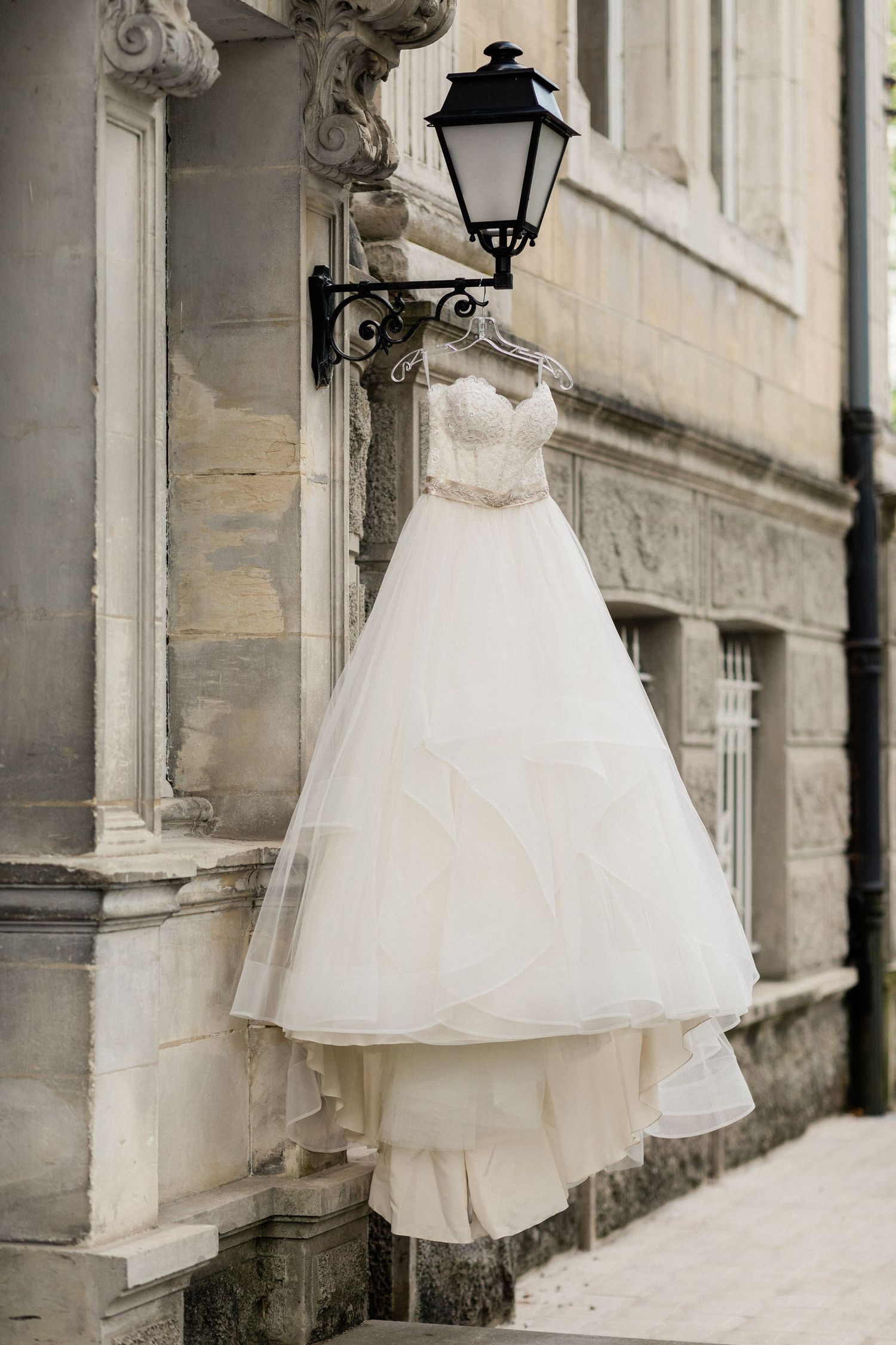 Wedding dress hanging detail shot with soft natural lighting
