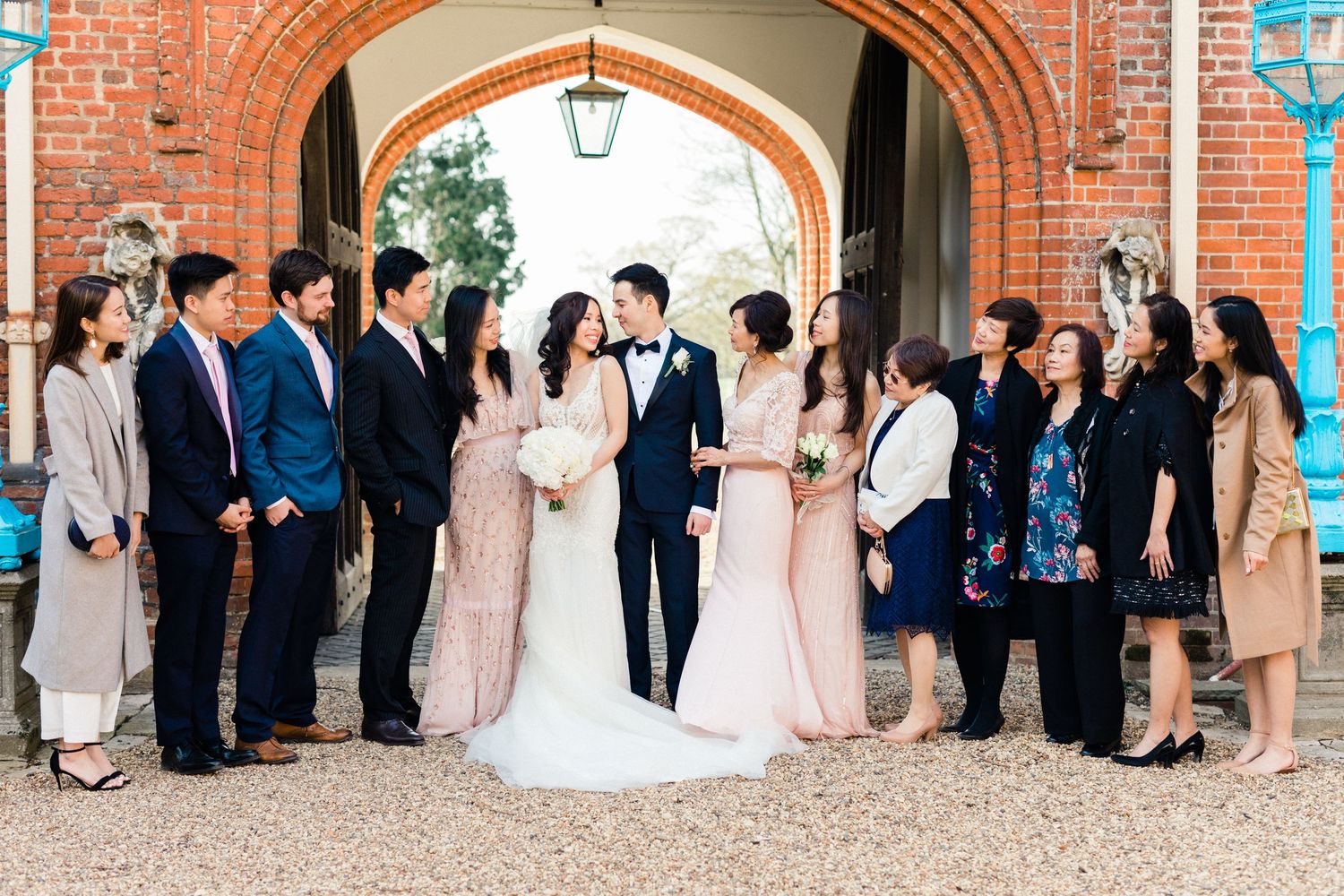 Couple with their blended family during group portraits – relaxed wedding at Gosfield Hall Essex