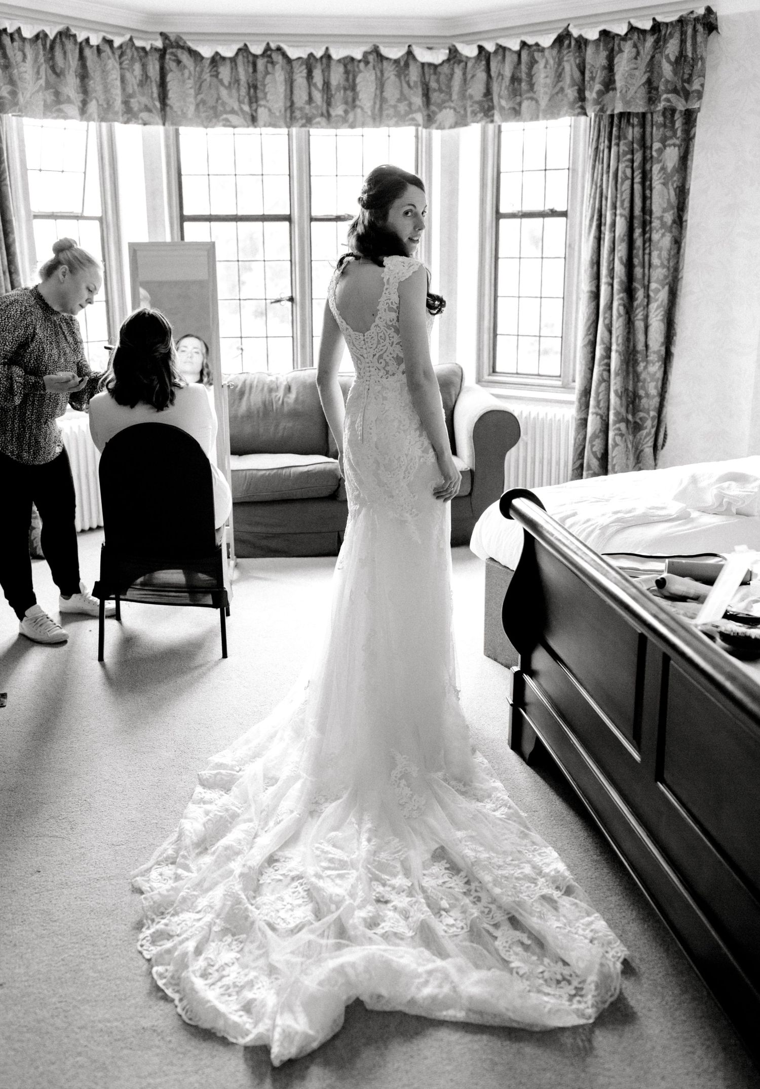Back of the dress showing train and button details in big window light - Hoath House candid wedding photography
