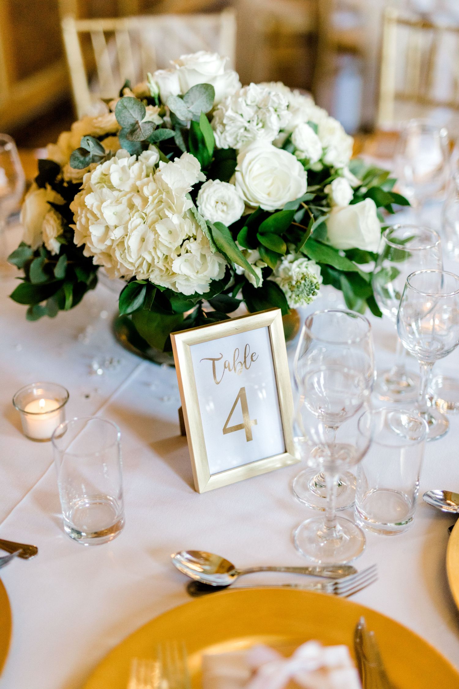 Detail shot of beautiful flower centrepiece in reception Gosfield Hall Essex - candid wedding photography