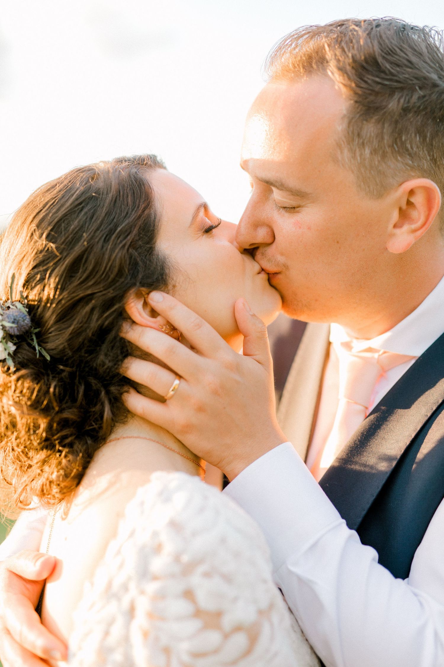 Bride and groom sharing intimate kiss during magical golden hour wedding photography in London