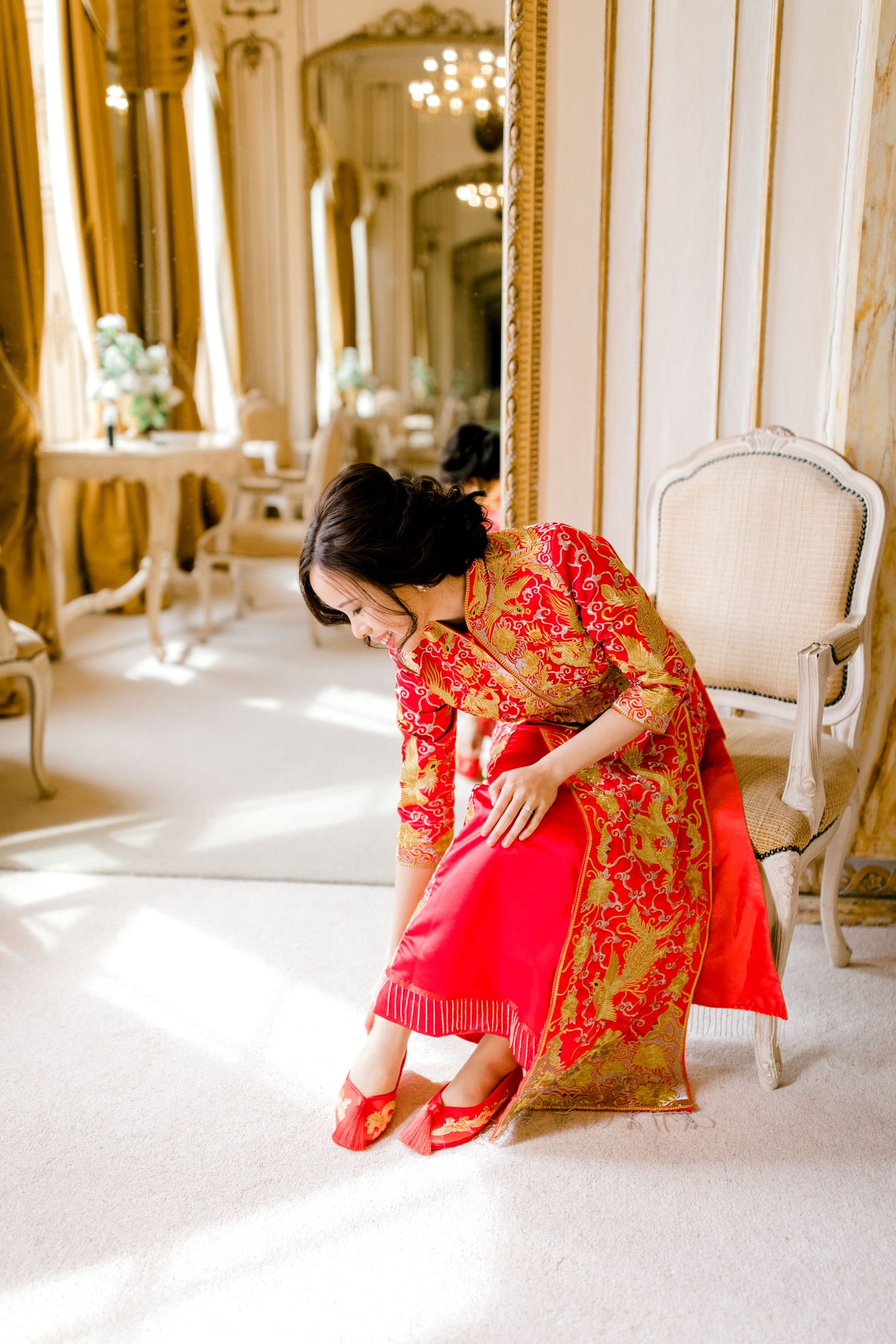 Bride sitting by the window, taking a quiet moment before the day begins – Gosfield Hall Essex - candid wedding photography