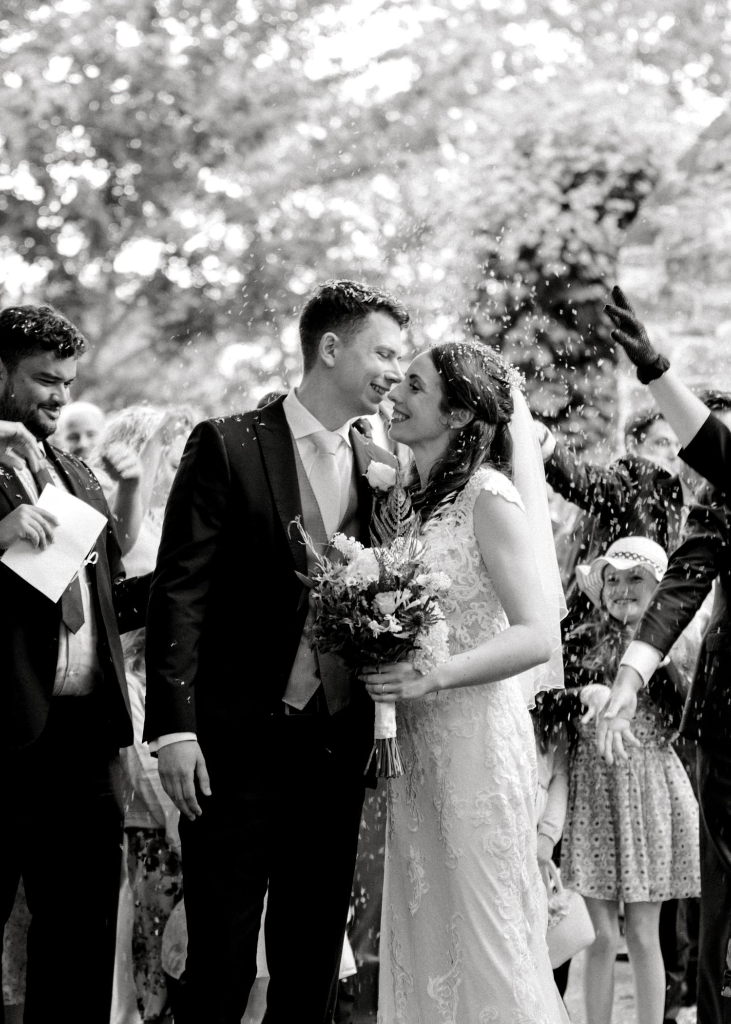 Confetti shot of bride and groom kissing following a church ceremony in Edenbridge, Kent