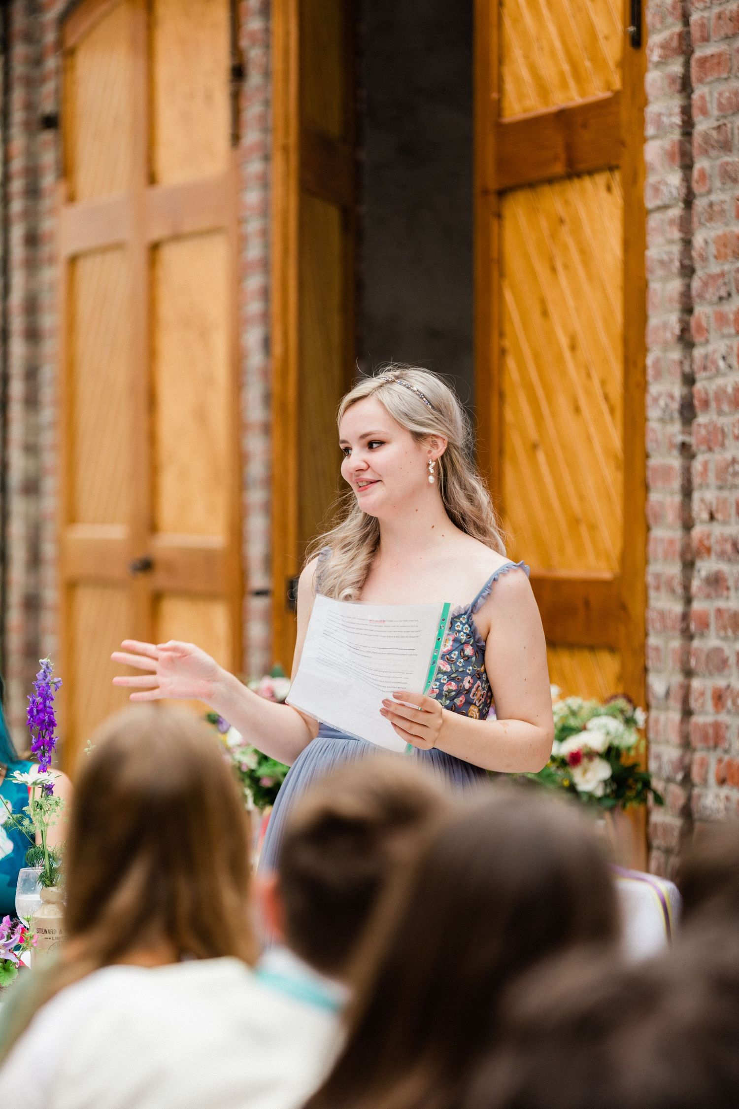 Candid photo of maid of honour speaking with emotion at chateau wedding venue in France