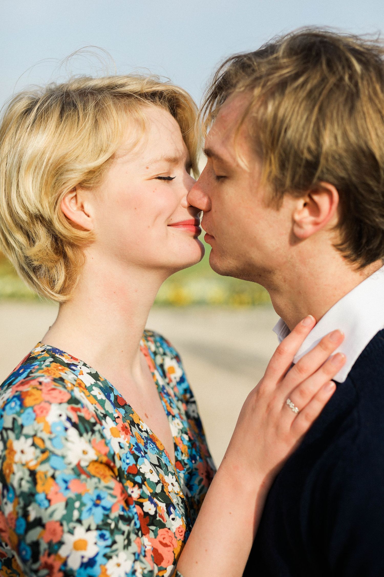 Bride-to-be and groom embracing in sunrise golden light during professional engagement shoot in Paris France