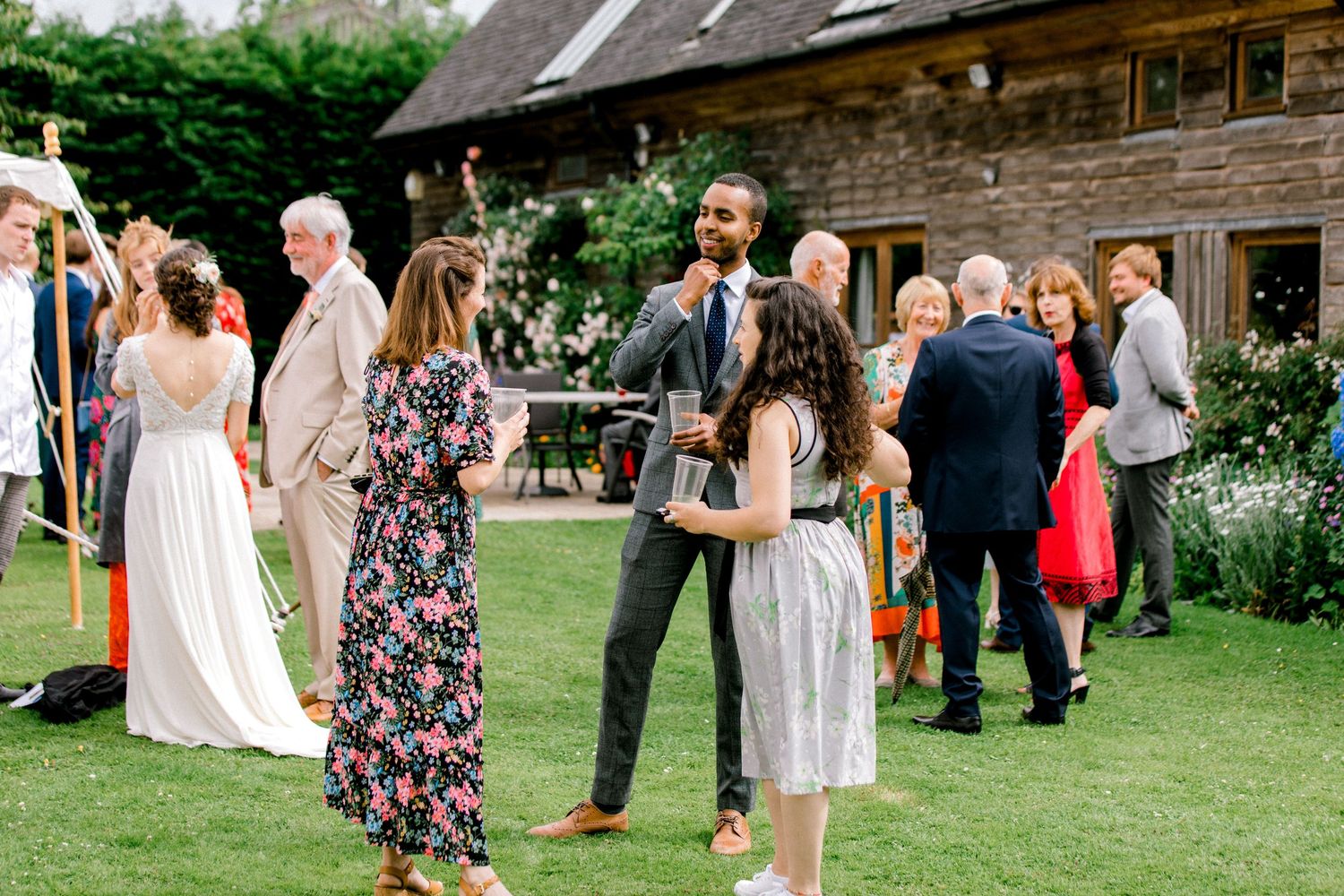 Candid photo of guests chatting during cocktail hour at London wedding