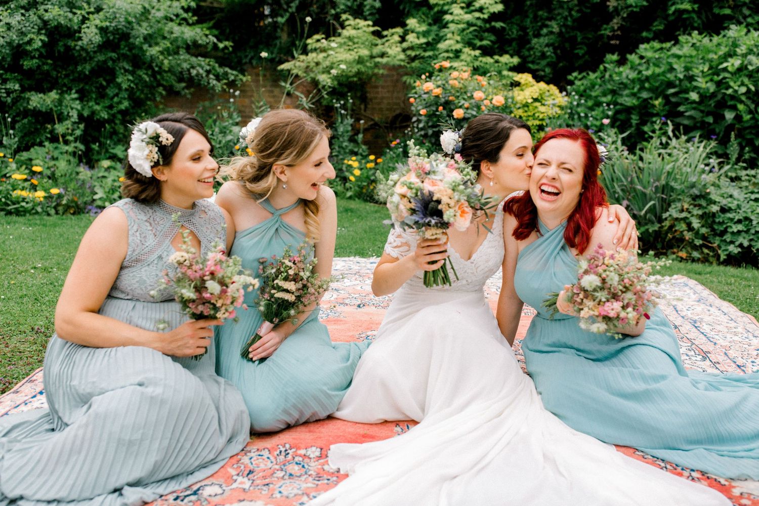 Candid moment of bridal party laughing in golden-hour light at summer London wedding