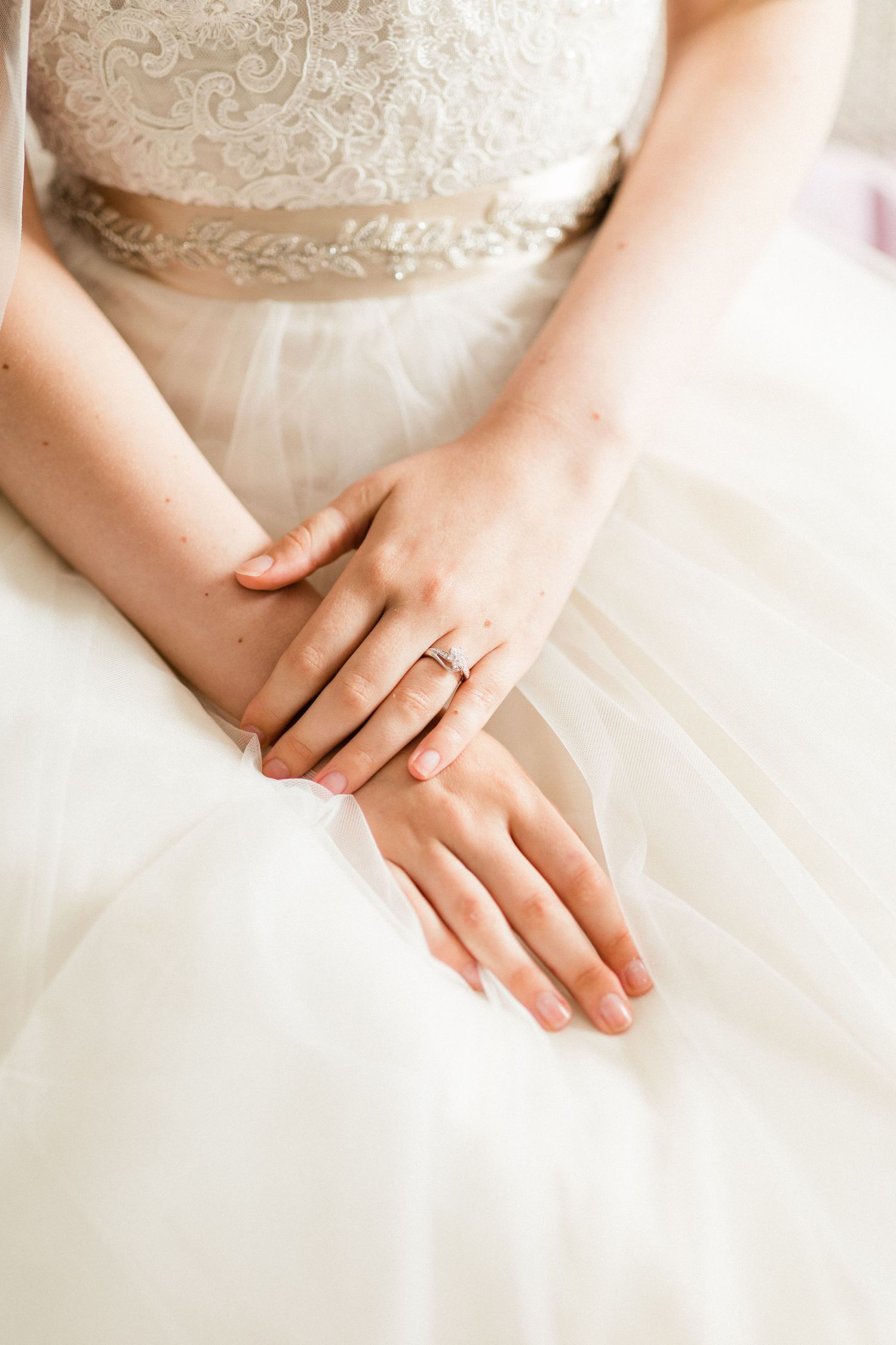 Close-up of bride's engagement ring on hand during bridal portrait session