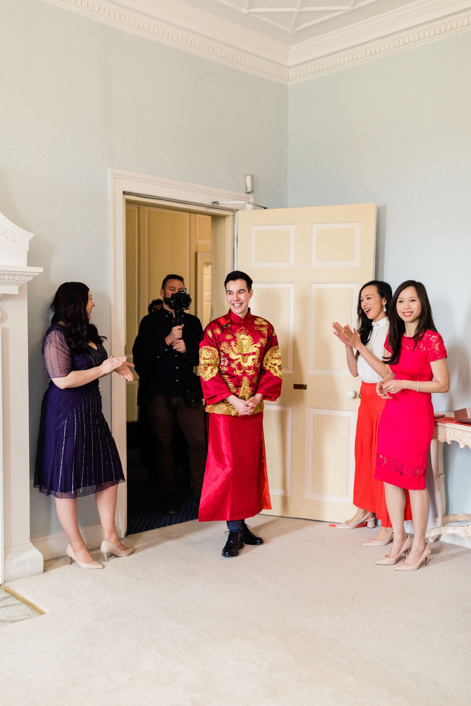 Groom and groomsmen entering tea ceremony Gosfield Hall Essex - candid wedding photography