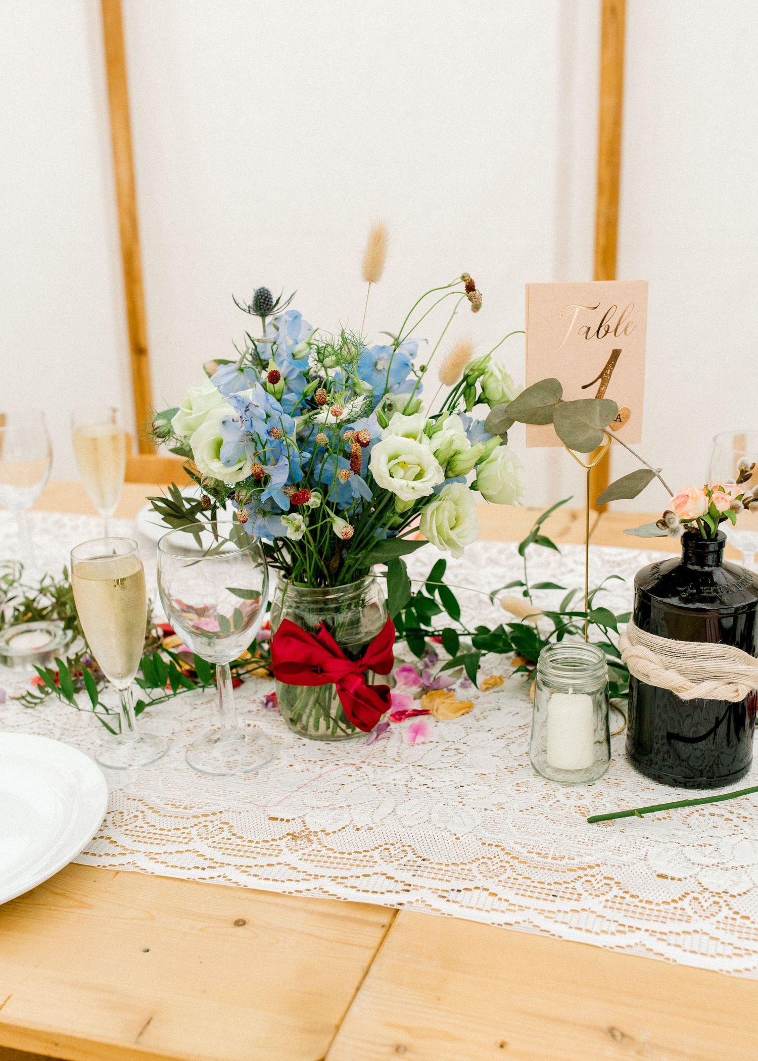 Centrepiece which is a bouquet of wildlflowers for wedding guests' table - detail shot in summer garden wedding London